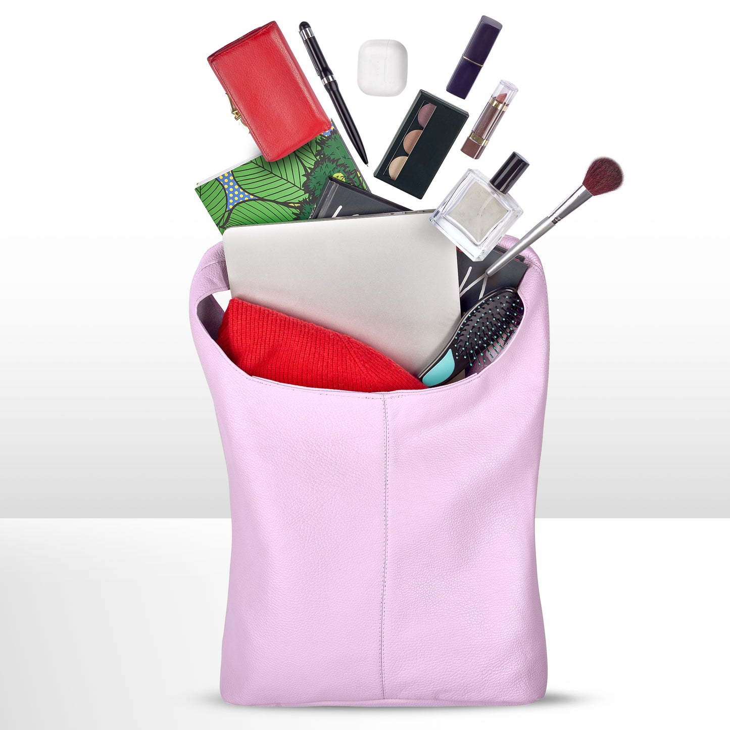 Pink tote filled with a laptop, cosmetics, a sweater, and various accessories.