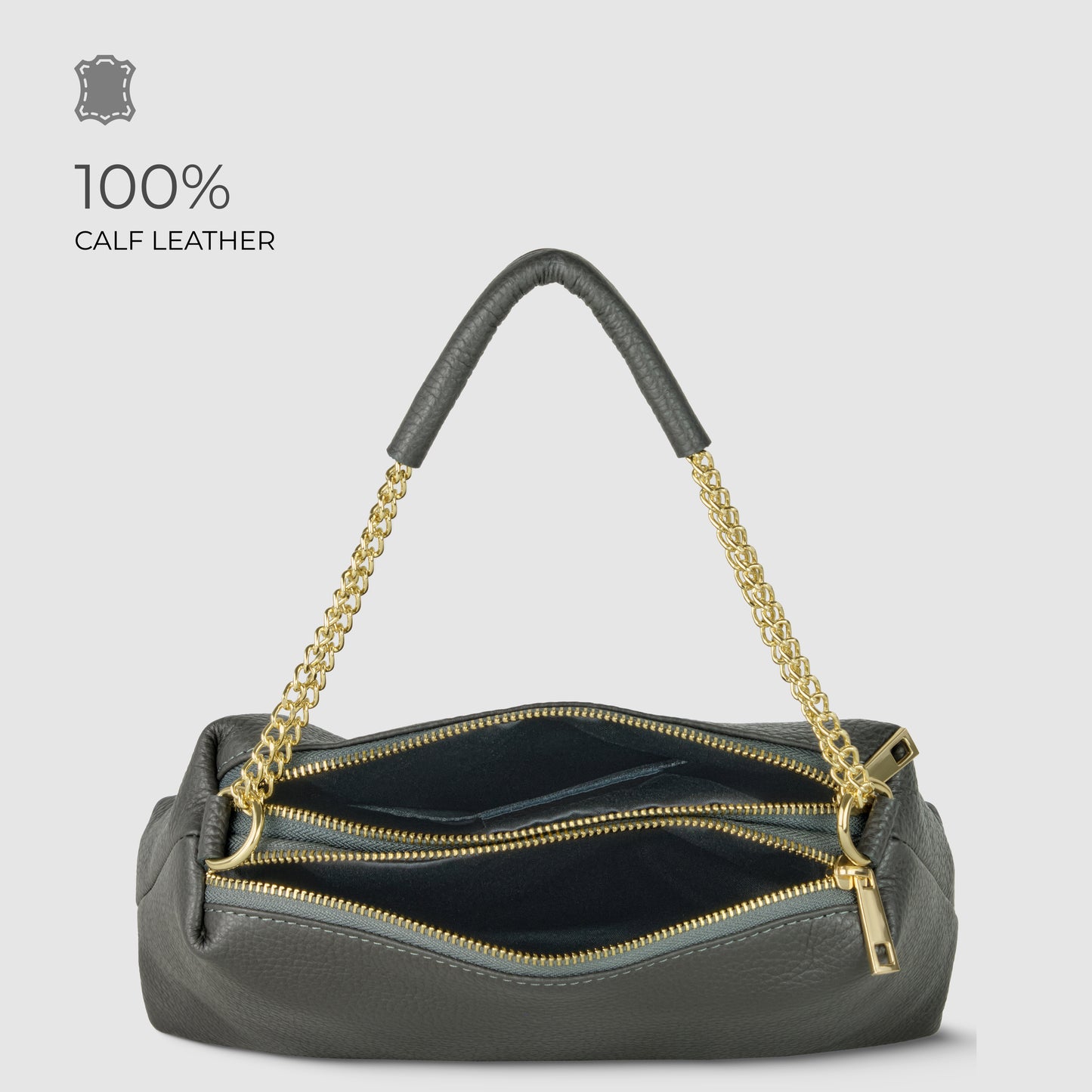 A luxury shoulder bag in dark gray calf leather with gold chain handles and two zippered compartments, shown open to reveal the interior. Text on the image reads “100% CALF LEATHER.”.