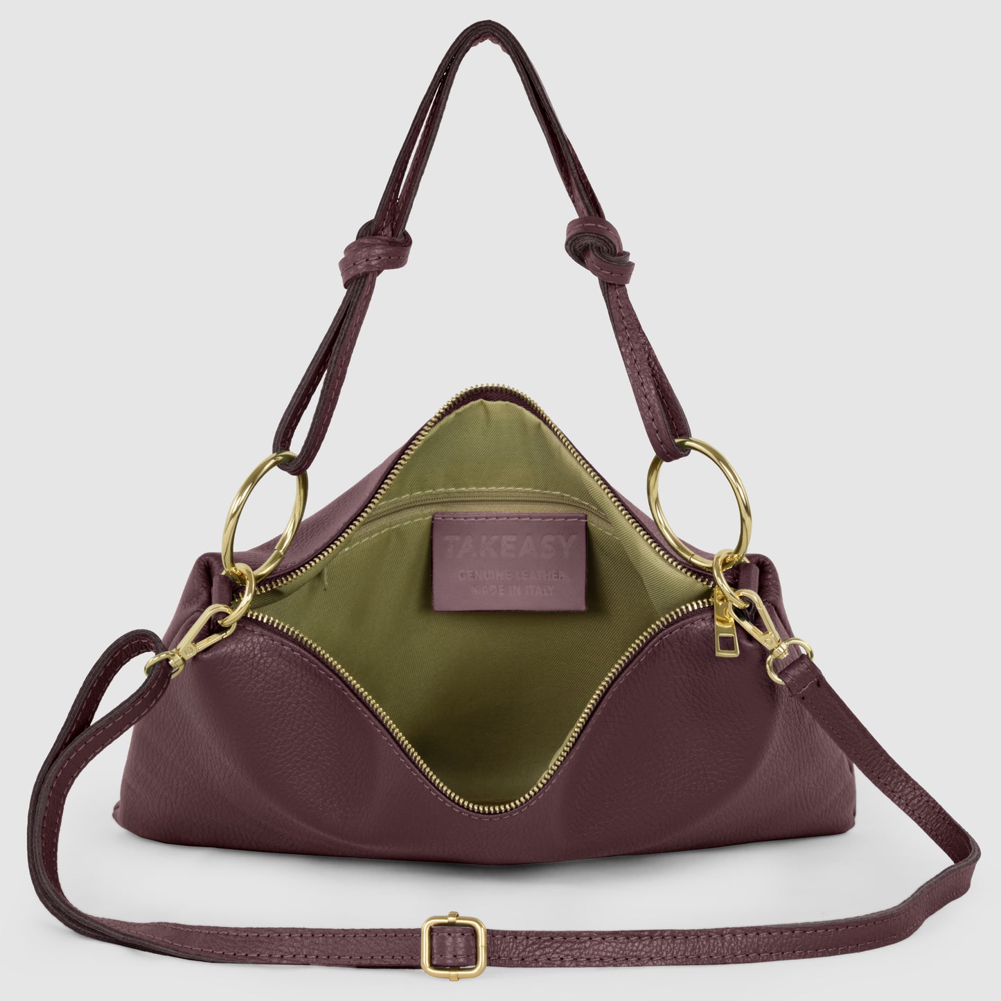 A structured, maroon Italian leather handbag with gold hardware and green fabric lining, shown open to reveal an interior pocket and a TAKEASY label. Features adjustable handles and a detachable shoulder strap for versatile crossbody bag wear.