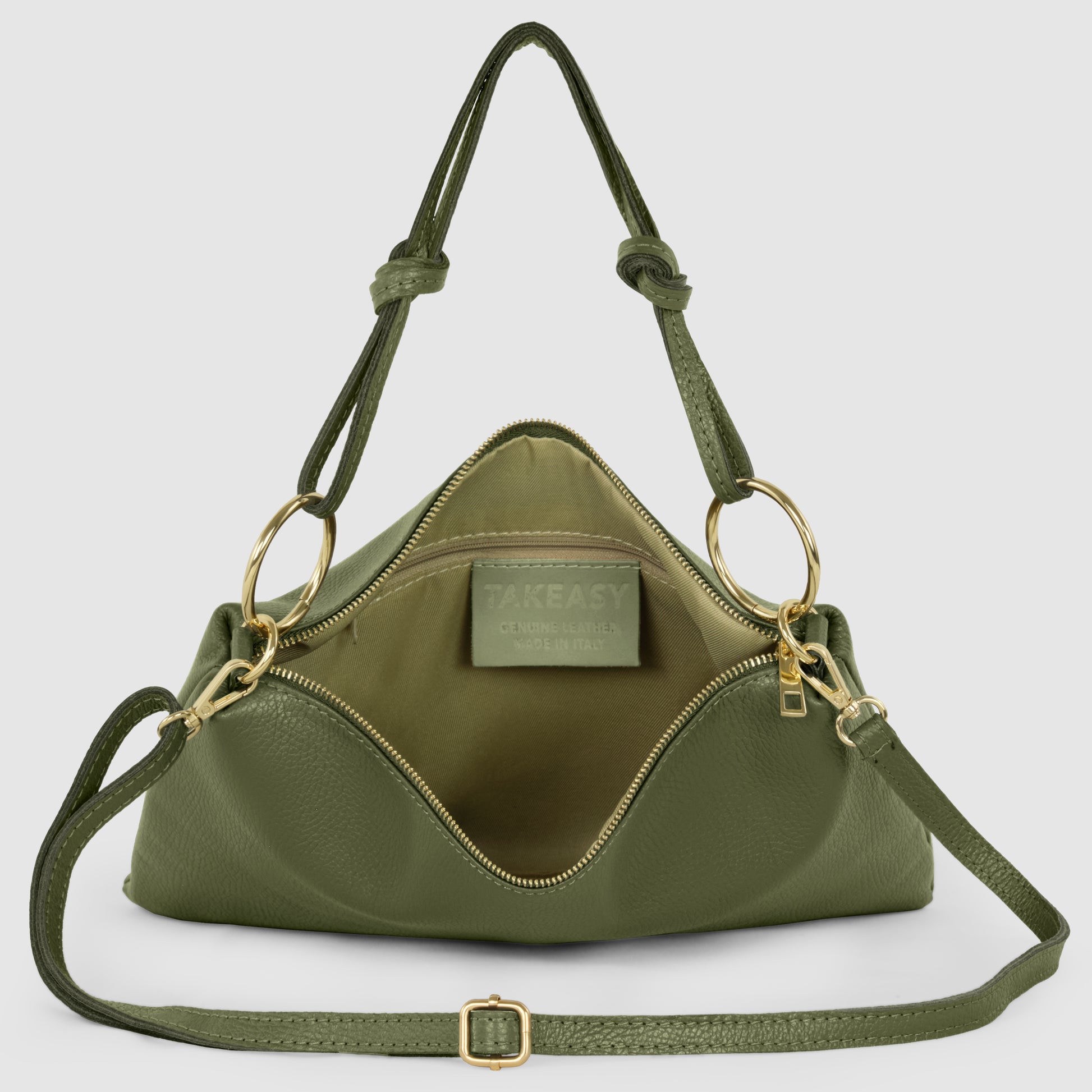 An olive green structured zippered purse crafted from real calf leather, with gold hardware, double handles, and a zippered opening, displayed open to reveal the interior lining and a visible label inside.