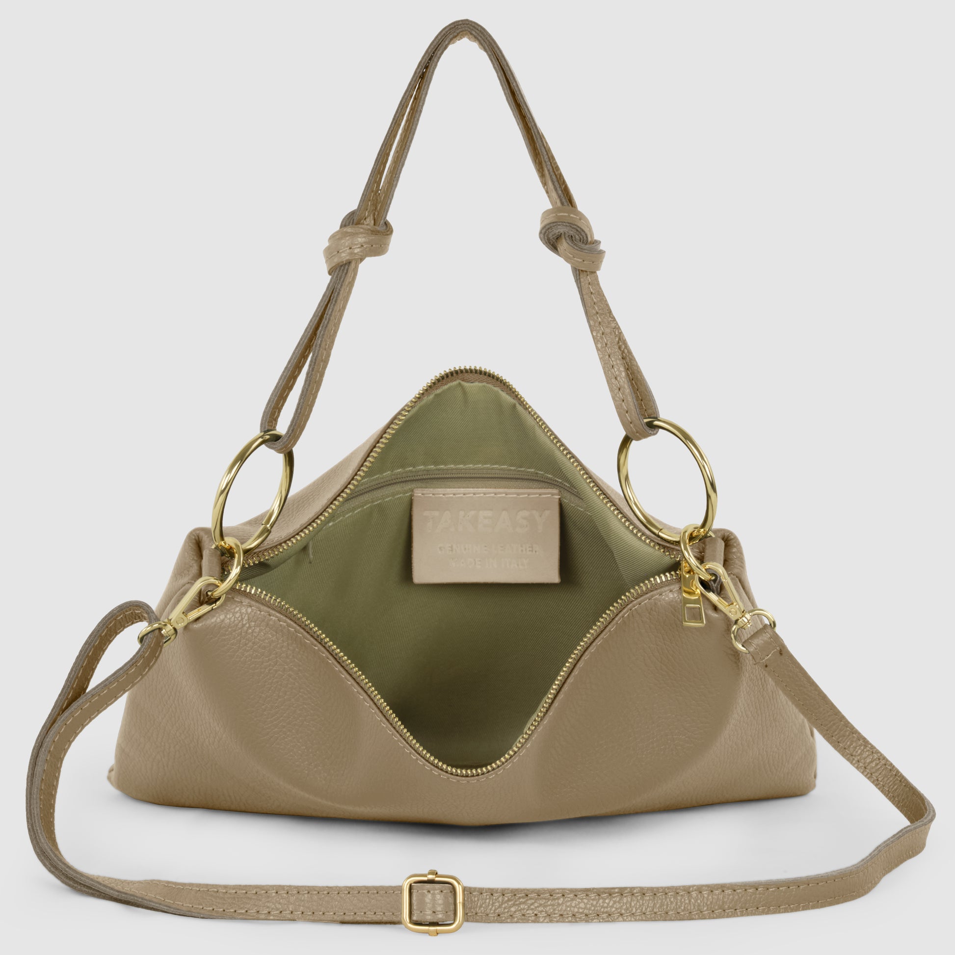 A beige Italian leather purse with gold hardware is shown open, revealing a green fabric interior and a pocket with a TAKEASY label. This structured zippered handbag features an adjustable shoulder strap and two handles.