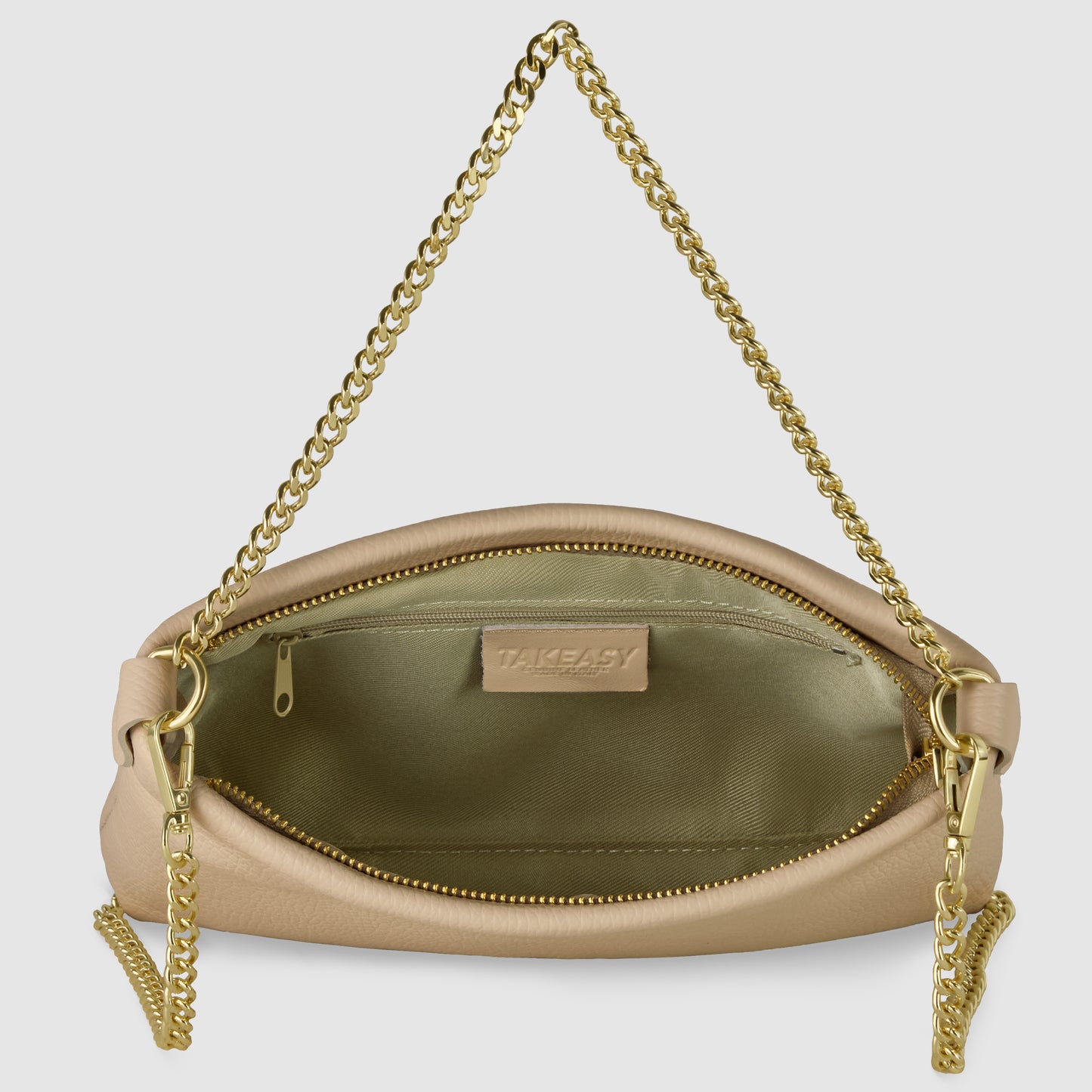 A beige Italian leather crossbody purse with a gold chain strap, open to reveal its light green interior lining and a zippered pocket with a label that reads TAKEASY.