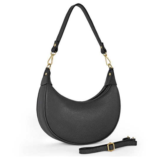 A black crescent-shaped leather handbag, featuring a textured finish, gold-tone hardware, and a detachable strap, highlights artisan craftsmanship against a white backdrop.