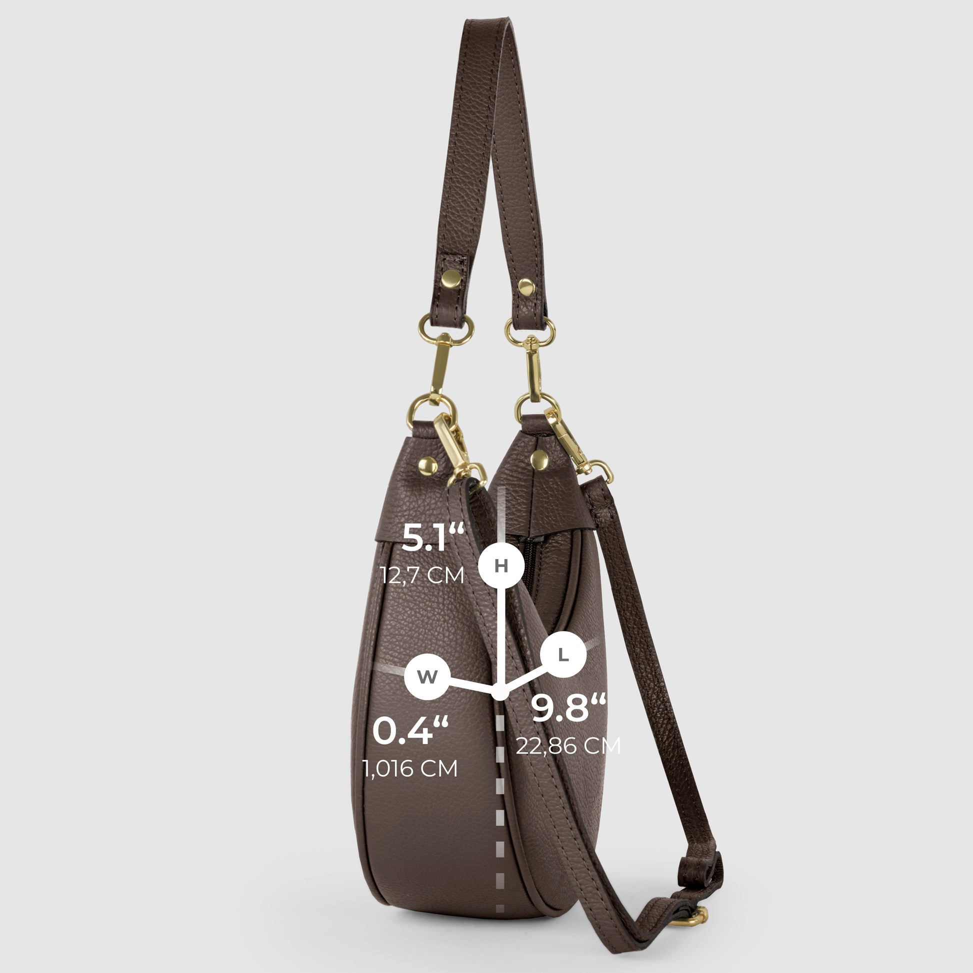Side view of a crescent-shaped handbag in brown Italian calf leather with gold hardware, highlighting artisan craftsmanship. Labeled dimensions: 5.1 (12.7 cm) height, 0.4 (1.016 cm) width, and 9.8 (22.86 cm) length.