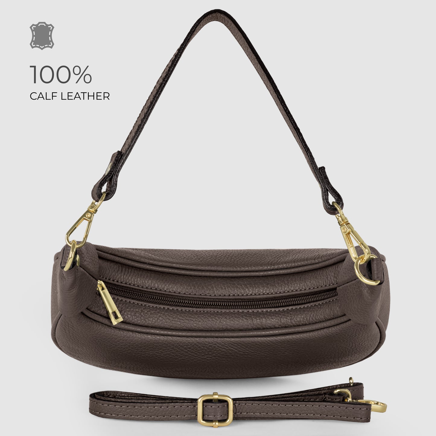 A brown, crescent-shaped handbag crafted from Italian calf leather with gold hardware, artisan craftsmanship, a detachable short handle, adjustable strap, and zippered compartments—displayed on a plain light background.