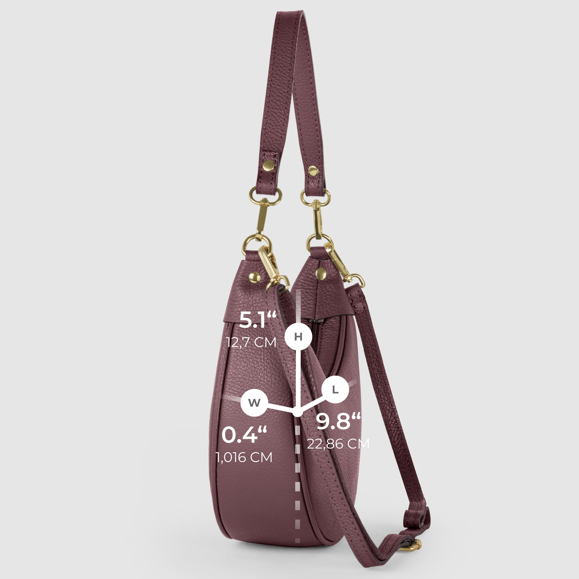 Side view of a mauve crescent-shaped handbag in Italian calf leather with gold hardware, showing dimensions: height 5.1 (12.7 cm), width 0.4 (1.016 cm), and length 9.8 (22.86 cm) on a light gray background.