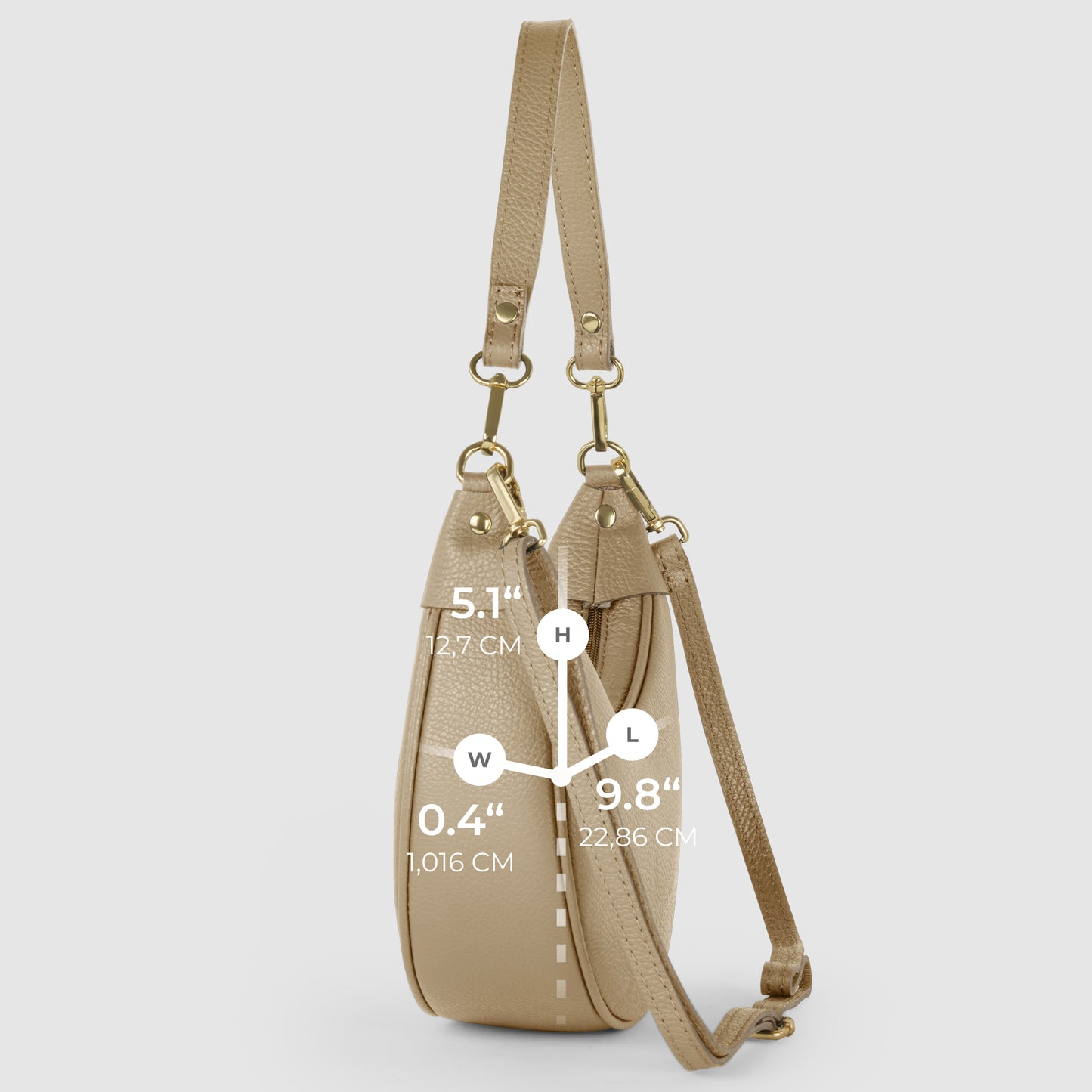 A crescent-shaped handbag in beige Italian calf leather is shown from the side on a light background, with white measurement labels for height (5.1/12.7 cm), width (0.4/1.016 cm), and length (9.8/22.36 cm).