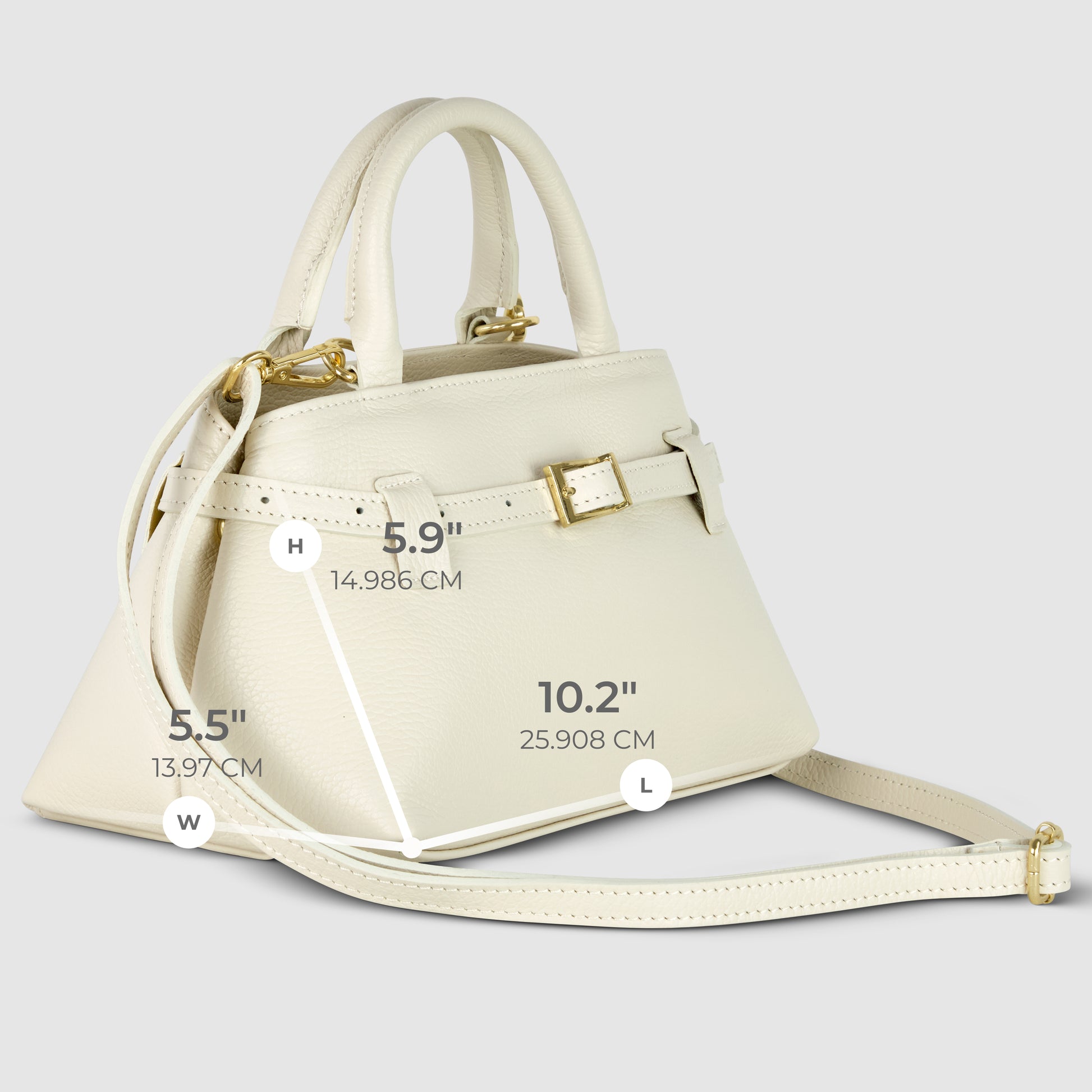 A cream-colored Italian leather handbag with gold hardware, a top handle, and a long shoulder strap. Handmade in Italy, this minimalist handbag measures 5.9" x 5.5" x 10.2".
