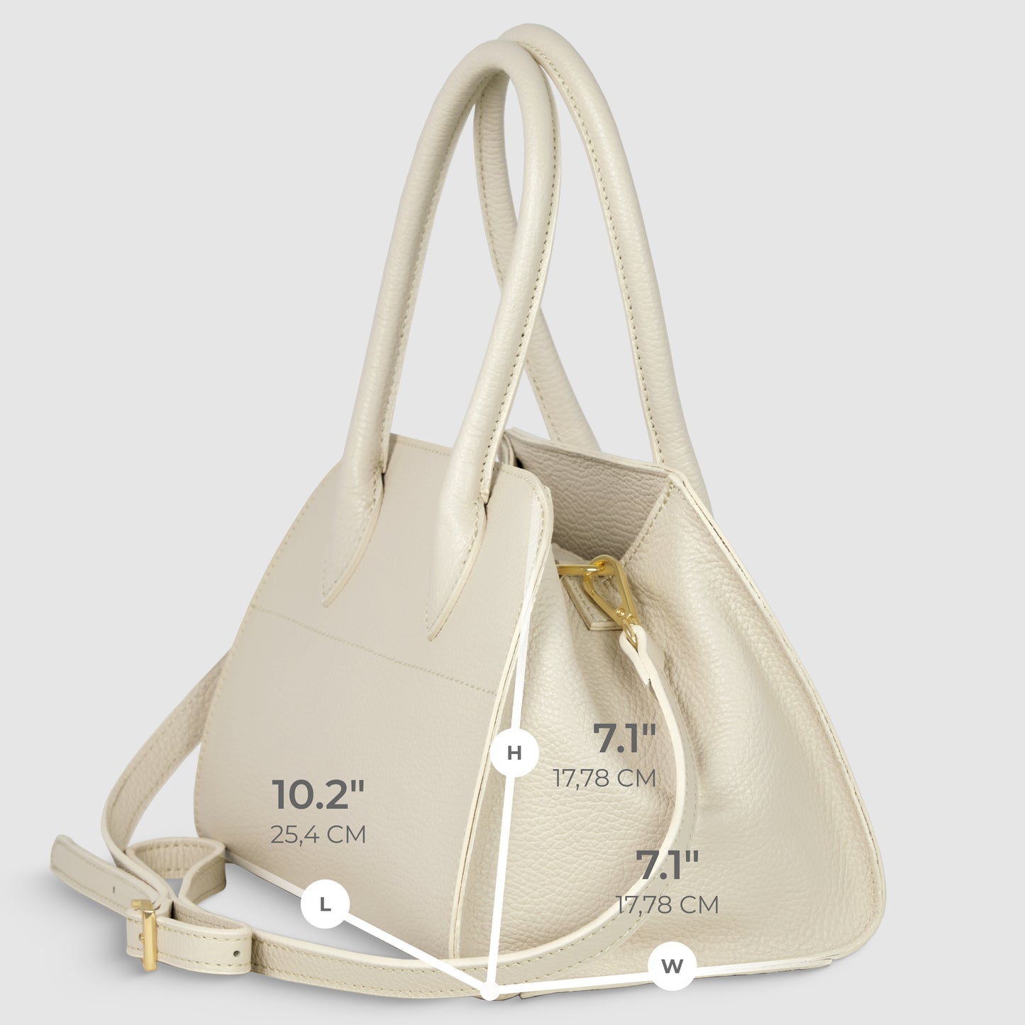 A cream-colored Italian leather handbag, handcrafted in Italy, with two handles and a shoulder strap is shown at an angle. Dimensions are labeled: length 10.2 (25.4 cm), height 7.1 (17.78 cm), and width 7.1 (17.78 cm).