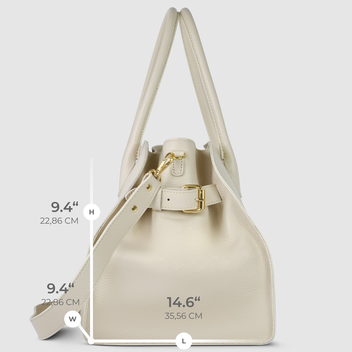 A cream-colored Italian leather bag with gold hardware stands upright. Dimensions are labeled: height and width 9.4 inches (22.86 cm), length 14.6 inches (35.56 cm). An adjustable strap completes this vintage satchel design.