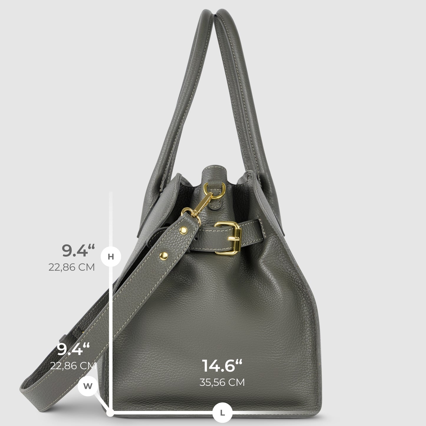A gray Italian leather bag with gold hardware is shown upright. Featuring a shoulder strap and two handles, this piece of Florentine leatherwork has labeled dimensions: height 9.4" (22.86 cm), width 9.4", and length 14.6" (35.56 cm).