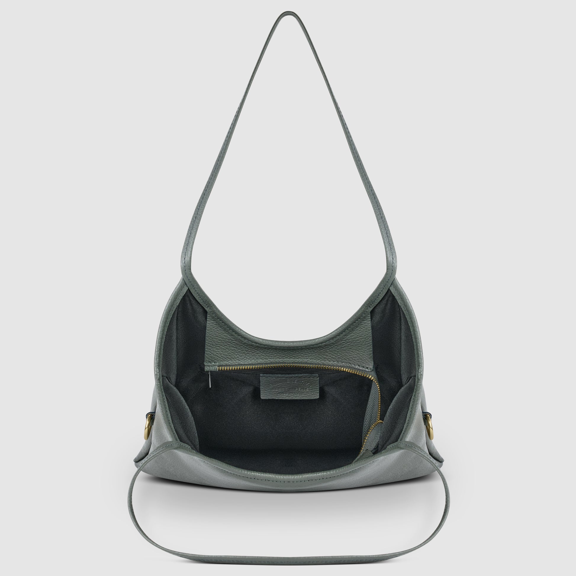 A gray Italian leather shoulder bag with a wide strap, open to reveal a spacious interior, an inner zippered pocket, and a leather patch—all showcasing Florentine craftsmanship against a plain white background.
