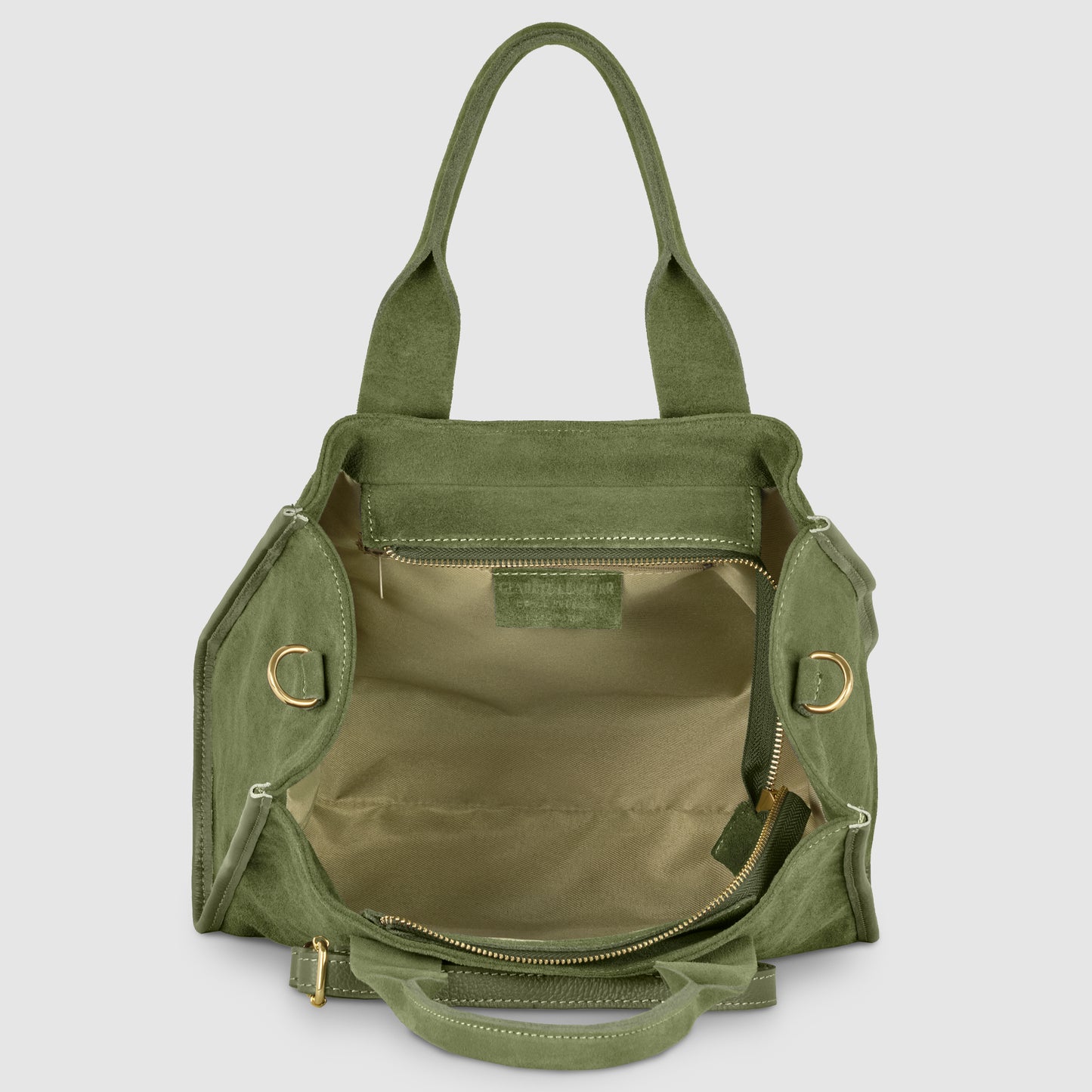 An open green suede bag with gold hardware, featuring Italian craftsmanship, a spacious beige interior, zippered pocket on the back wall, and double handles standing upright.