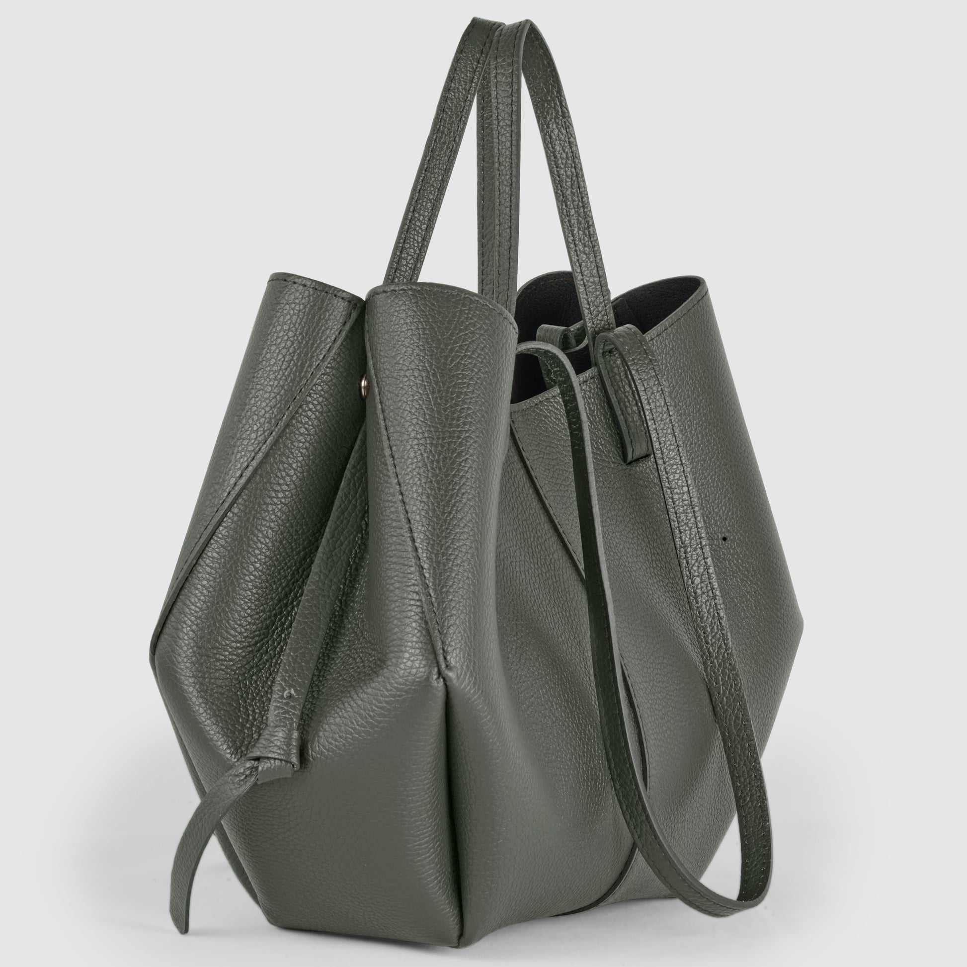 Dark green Italian leather handbag with double handles stands upright. This structured tote, handcrafted in Italy, measures 10.2 in (25.4 cm) high, 4.7 in (10.16 cm) wide, and 15 in (38.1 cm) long.