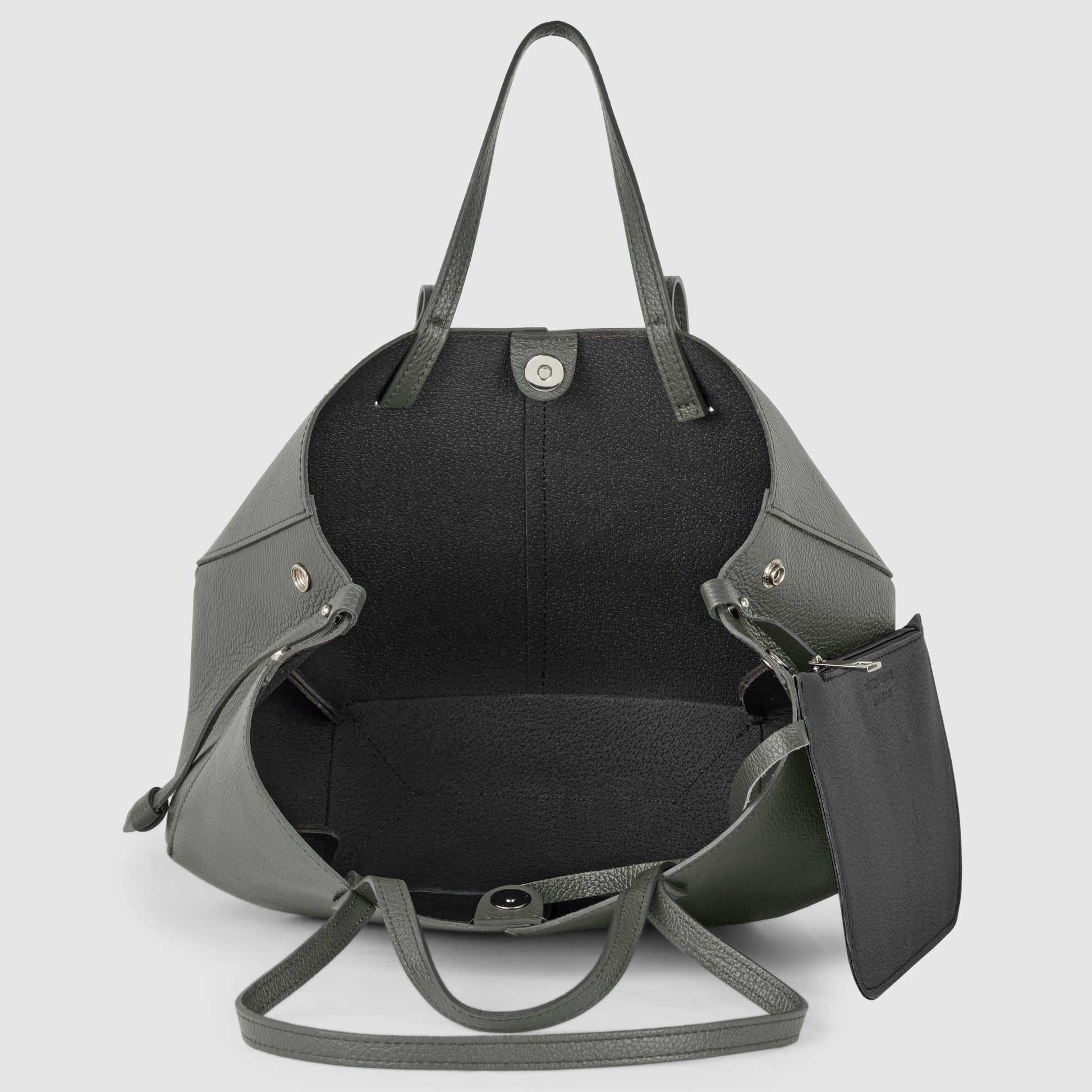A large, open, dark green Italian leather handbag with two handles, silver hardware, a snap closure, and a detachable black zip pouch inside, handcrafted in Italy and shown on a light gray background.