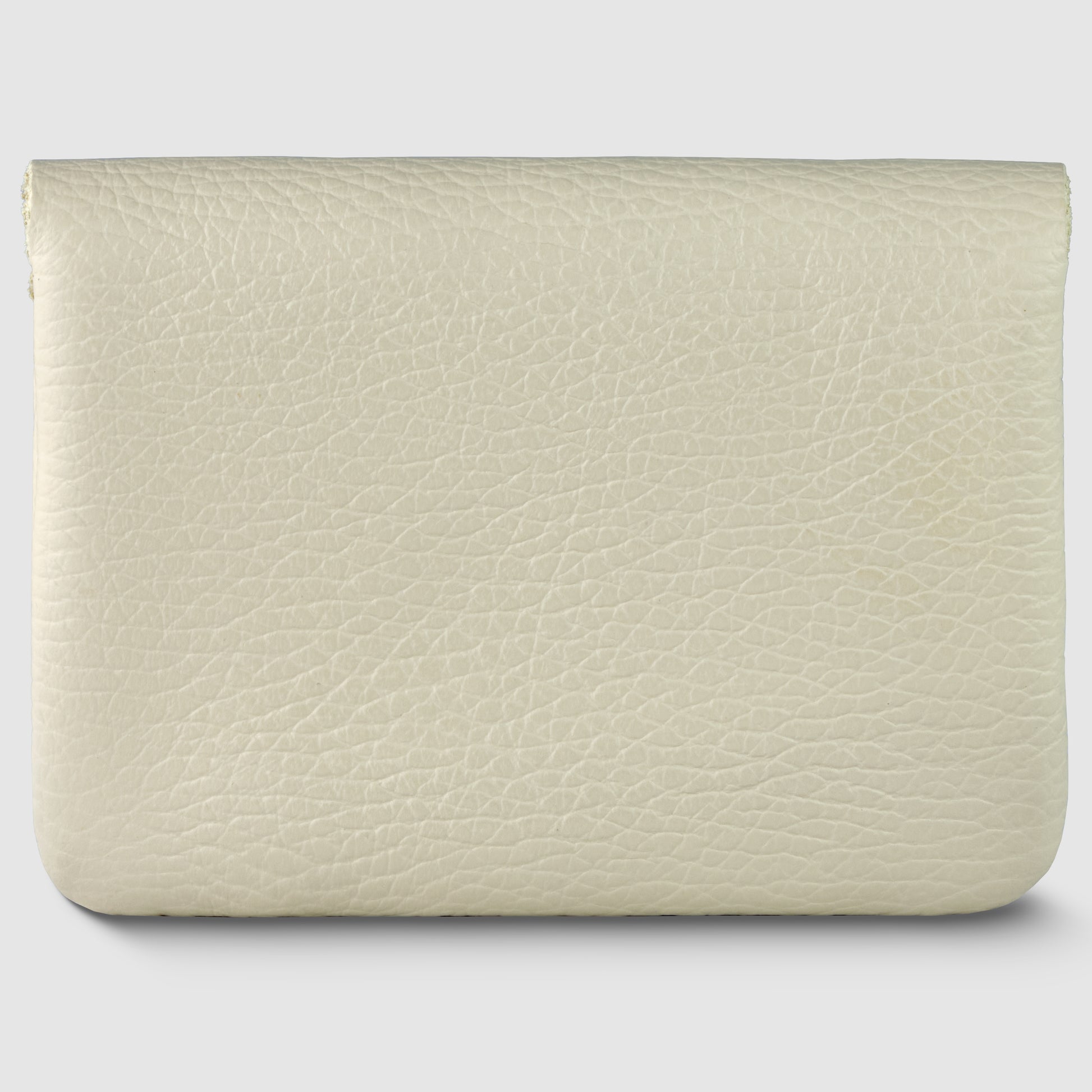 A beige, textured Italian leather wallet with a simple, rectangular shape, shown against a light gray background. The minimalist wallet is closed and features no visible zippers, buttons, or logos.