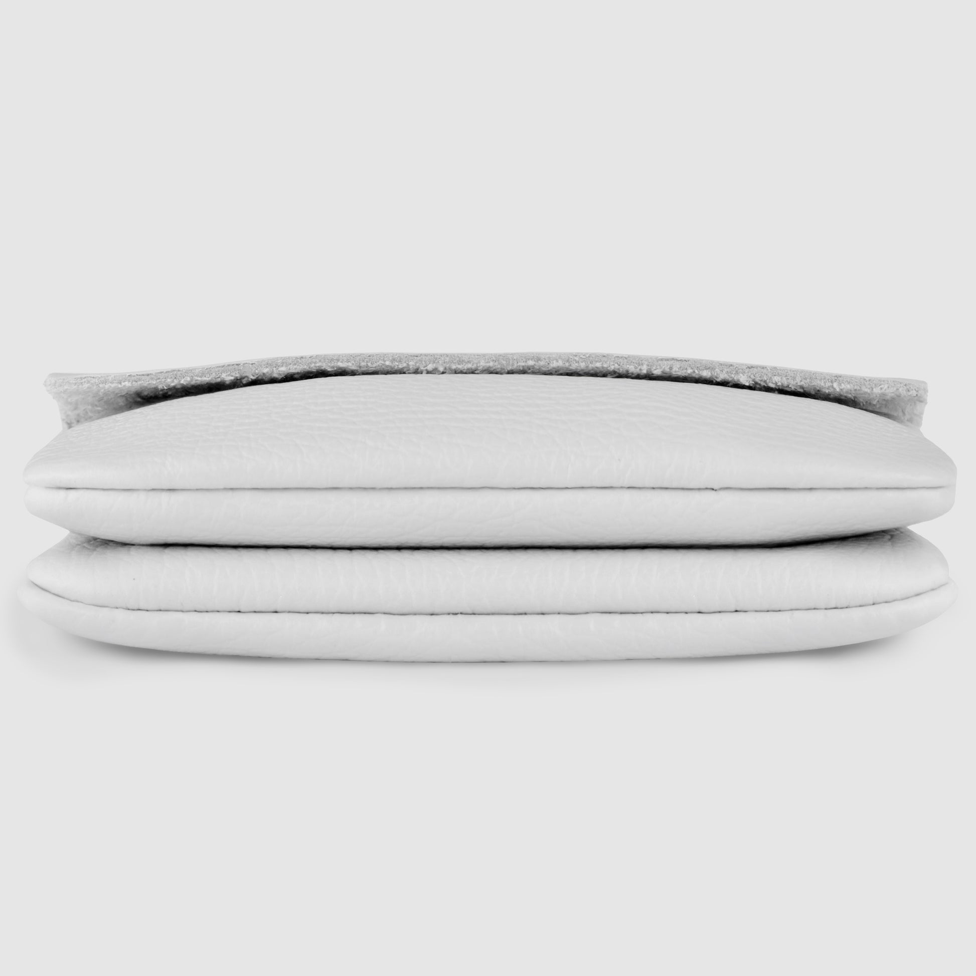 A close-up front view of a handmade wallet in textured white genuine calf leather, folded neatly to showcase Italian minimalism, set against a plain white background.