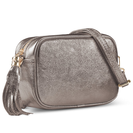 Metallic silver suede leather crossbody bag with rounded edges, gold-tone zipper, and tassel detail.
