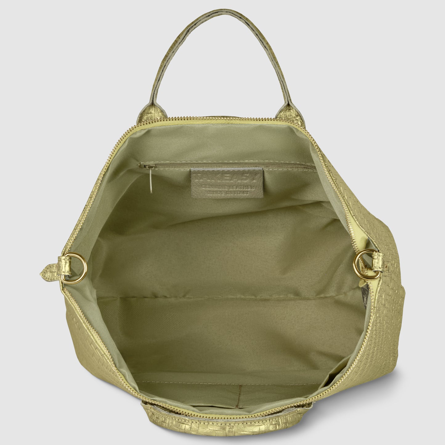 Open top view of a light gold Italian leather handbag with a handle, showing a spacious interior, a small zippered pocket inside, and gold hardware on each side. The bag has a structured design and a textured finish.