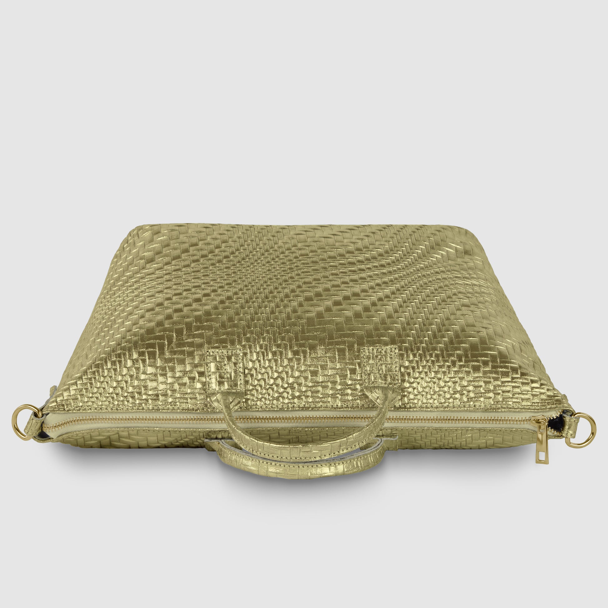 A gold, woven-texture laptop bag with two handles, a zipper closure, and metal rings for an optional shoulder strap, reminiscent of a sleek metallic suede bag, displayed against a plain light background.