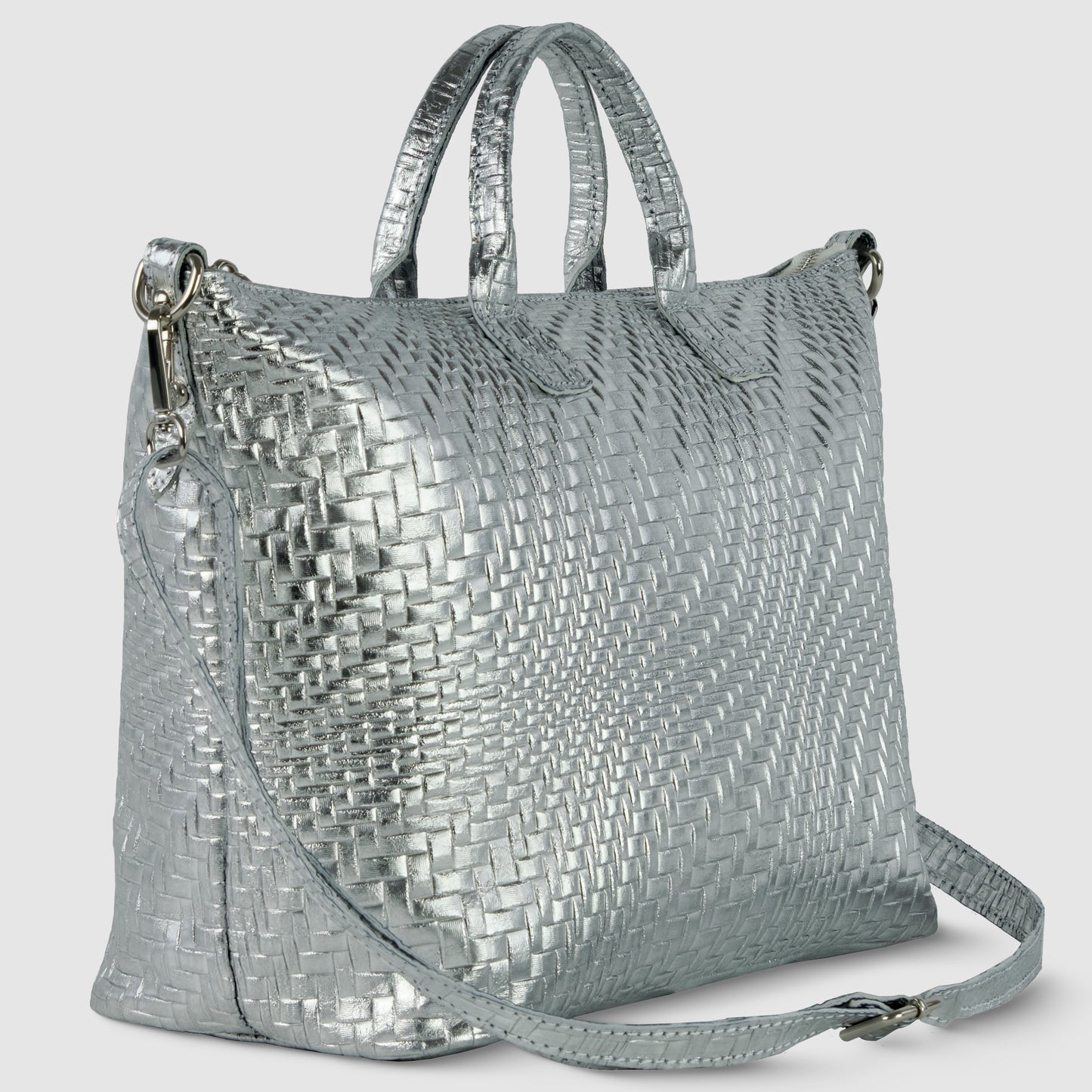 A metallic silver Italian leather handbag with a woven texture, two short handles, and a long adjustable shoulder strap, set against a light gray background.