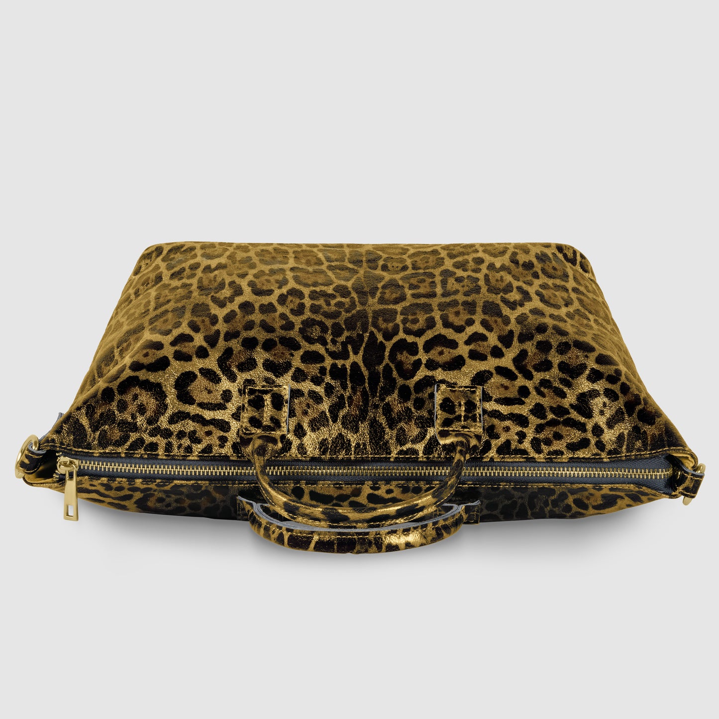 A flat, rectangular metallic leopard print handbag with two short handles and a gold zipper, displayed against a plain gray background.