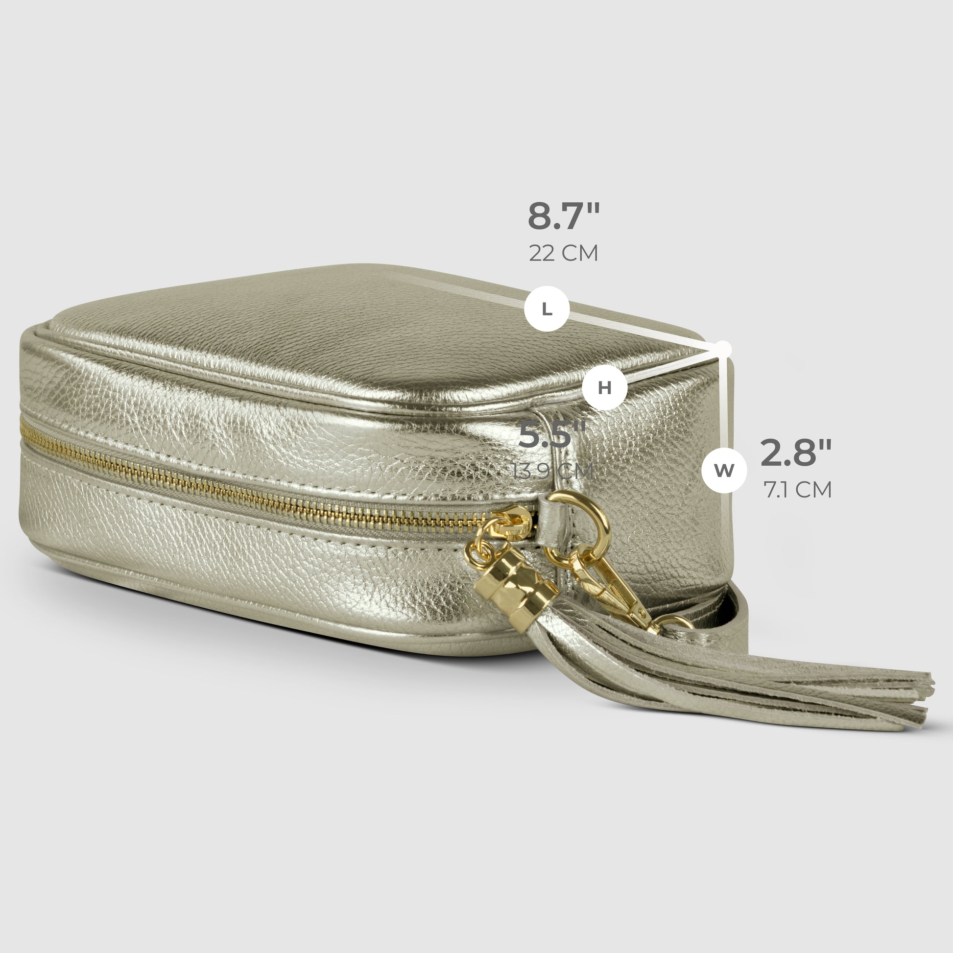 A metallic gold small rectangular purse with a tassel keychain is shown. Dimensions are labeled: length 8.7 (22 cm), height 5.5 (13.6 cm), and width 2.8 (7.1 cm).