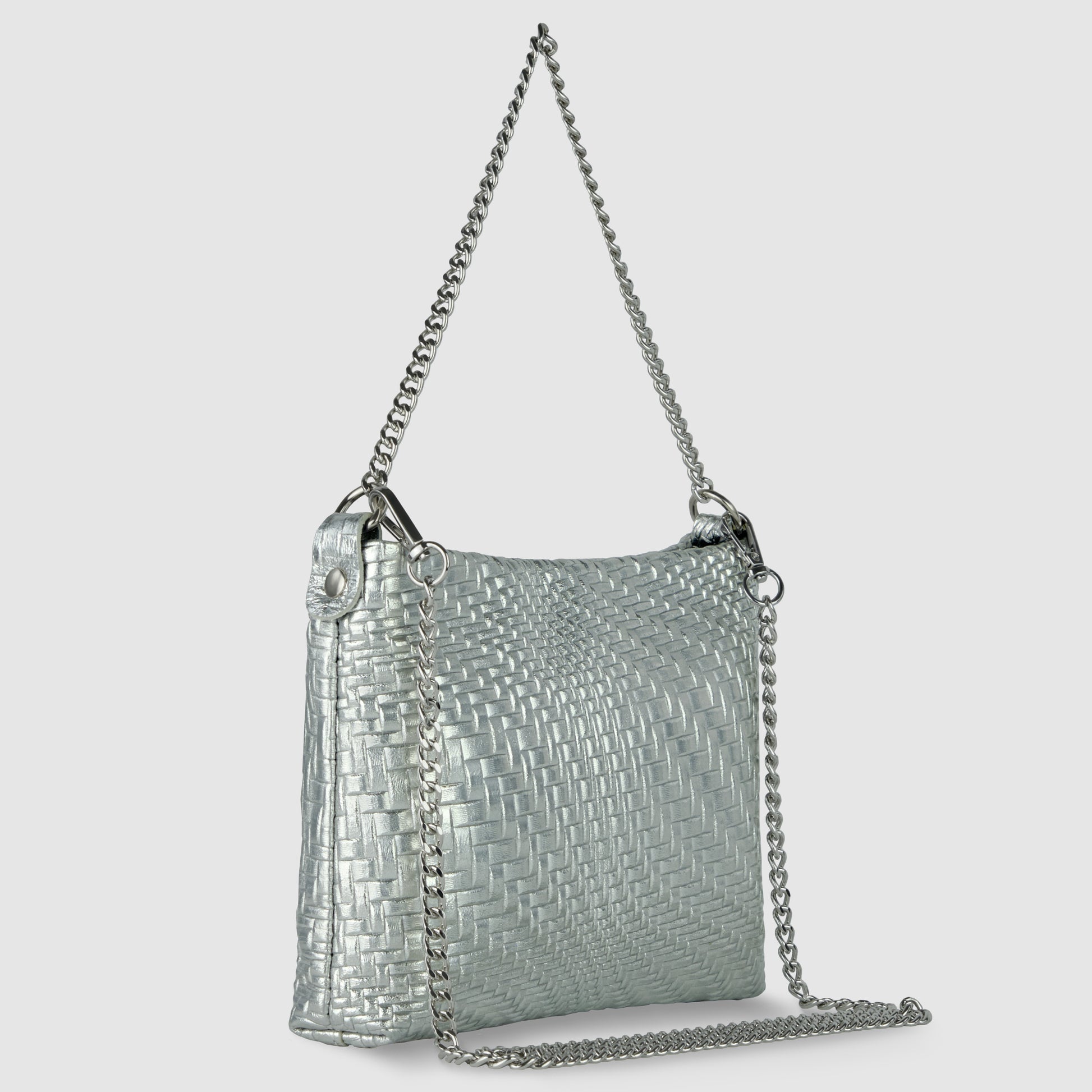 A metallic silver woven handbag with a rectangular shape, showcasing Florentine leathercraft and a long silver chain strap, shines with its textured surface against a plain light gray background.