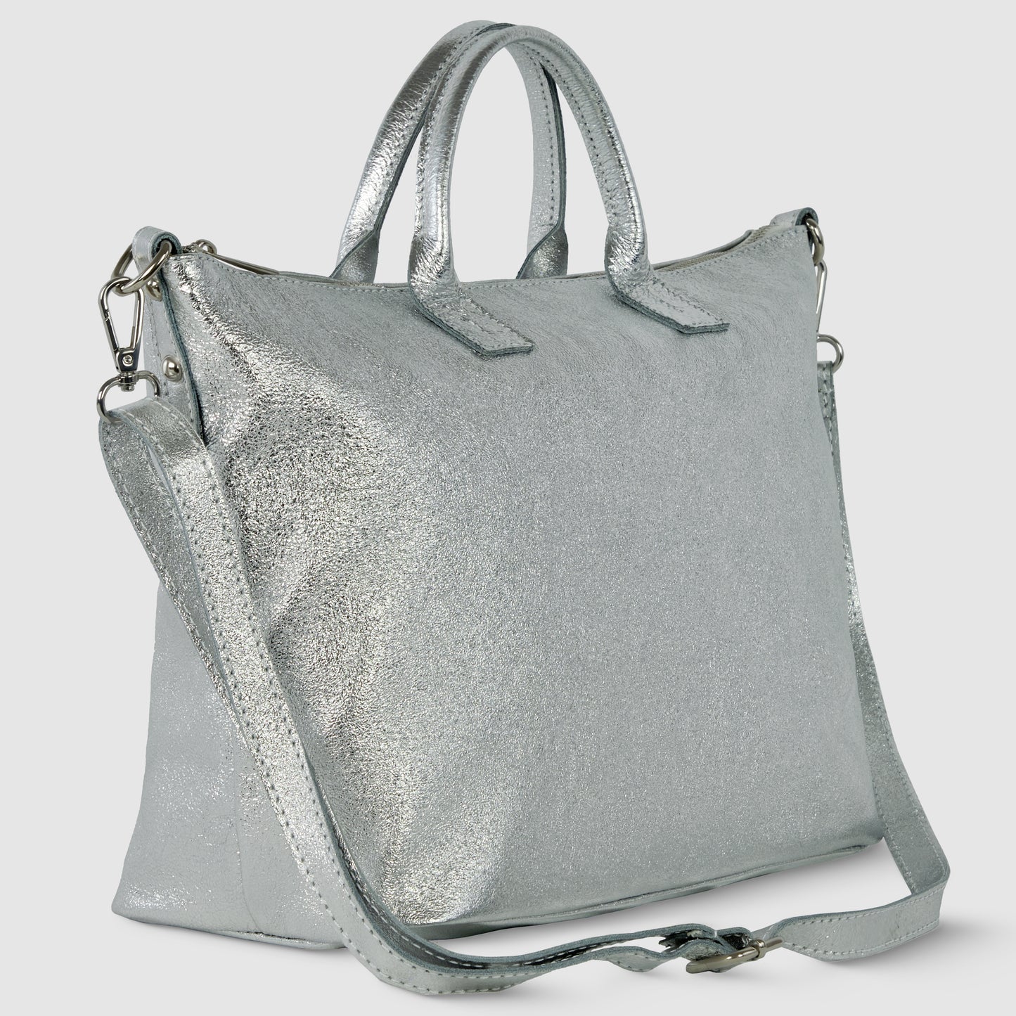 A metallic silver Italian handbag with short handles and a detachable, adjustable shoulder strap, shown against a plain light background. The bag has a smooth, shiny surface and a modern, structured design.