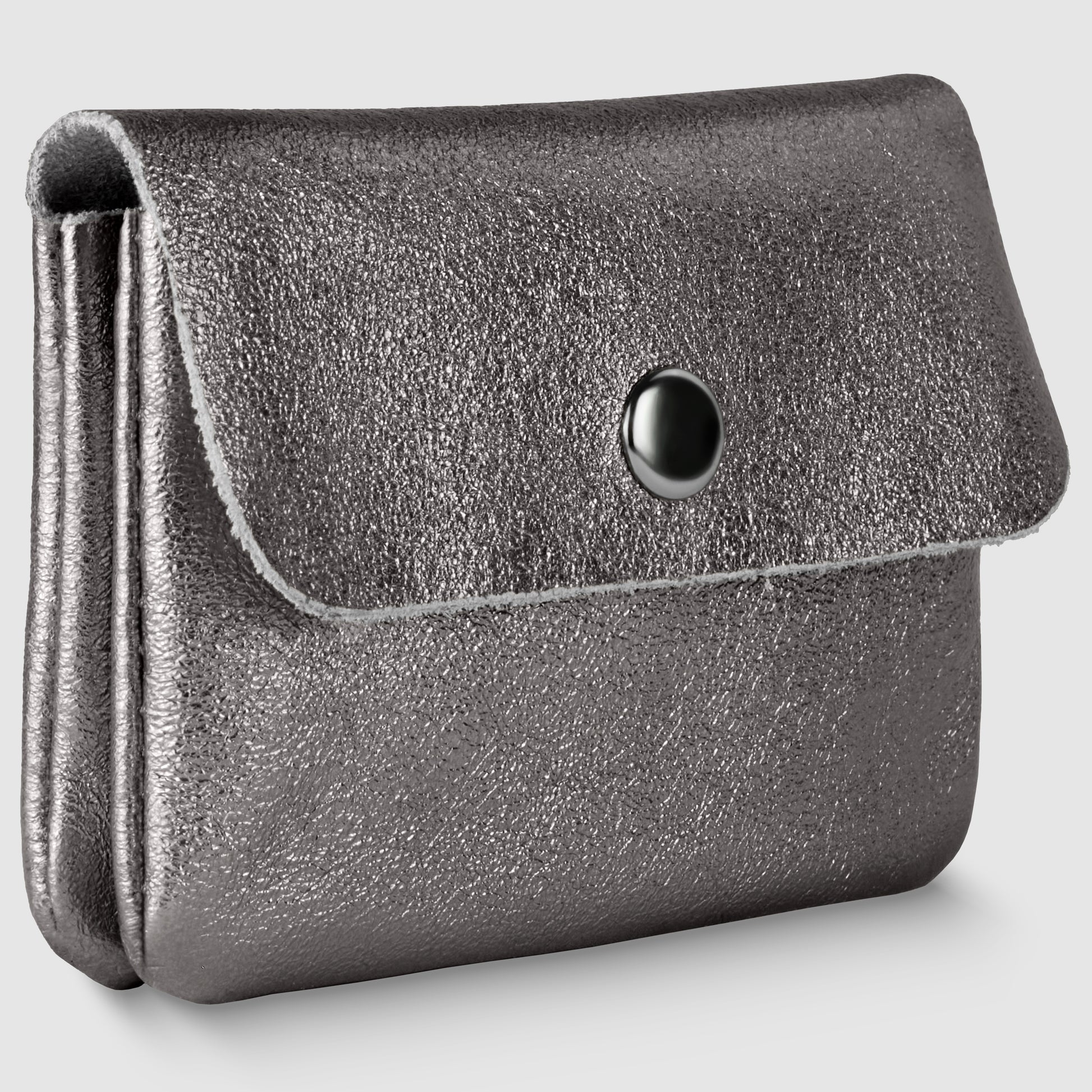 A metallic silver textured coin purse with a flap closure and black snap button, this women’s compact wallet exudes understated elegance, reminiscent of an Italian luxury wallet, shown on a plain light gray background.