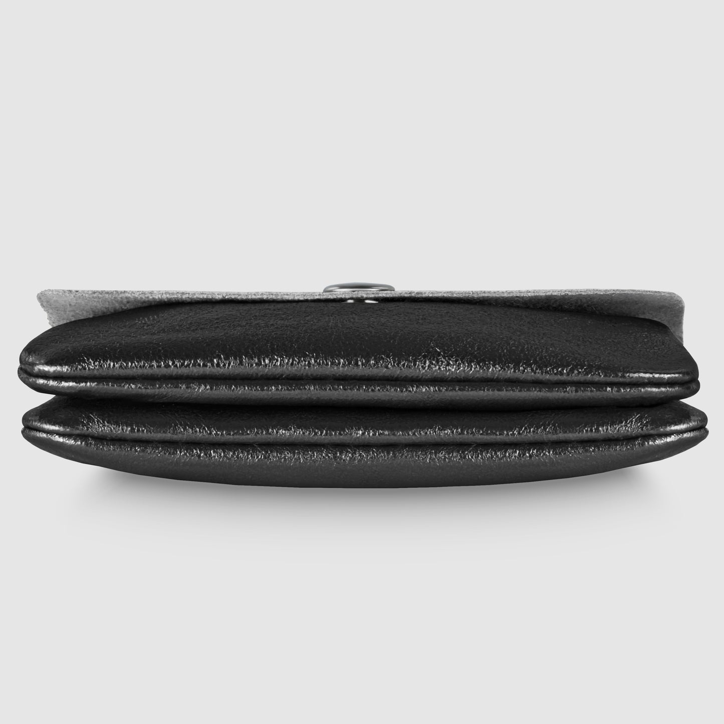 A compact women's wallet crafted from black leather, viewed from the side, with two main compartments and a metal clasp at the top—an elegant Italian luxury wallet set against a plain light gray background.