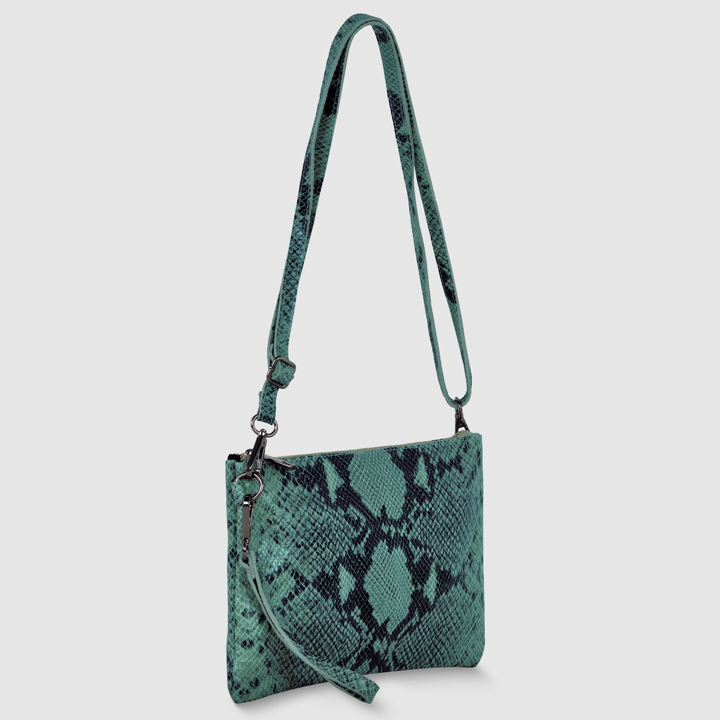 A teal python suede bag with a black snakeskin pattern, featuring a long adjustable strap and a detachable wristlet, effortlessly doubles as a stylish crossbody wristlet. Displayed against a light gray background.