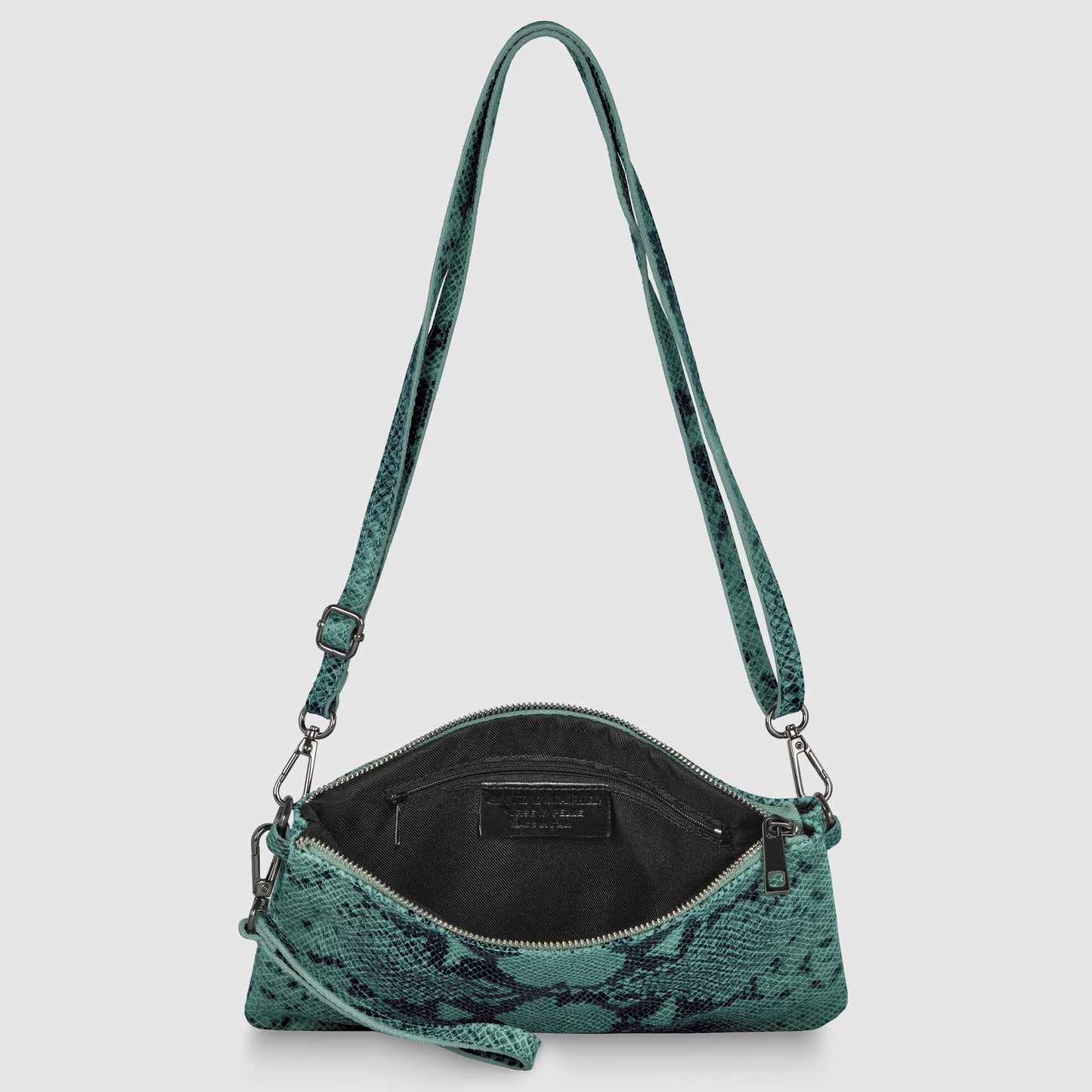 A small green python suede bag with a snakeskin pattern, wide shoulder strap, and zippered top, shown open to display the black interior and inner pocket.