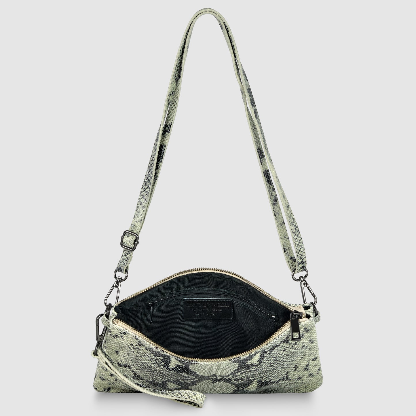 A small, rectangular python suede bag with a snakeskin pattern and zipper closure is shown open, revealing a black interior and adjustable strap, against a light gray background.