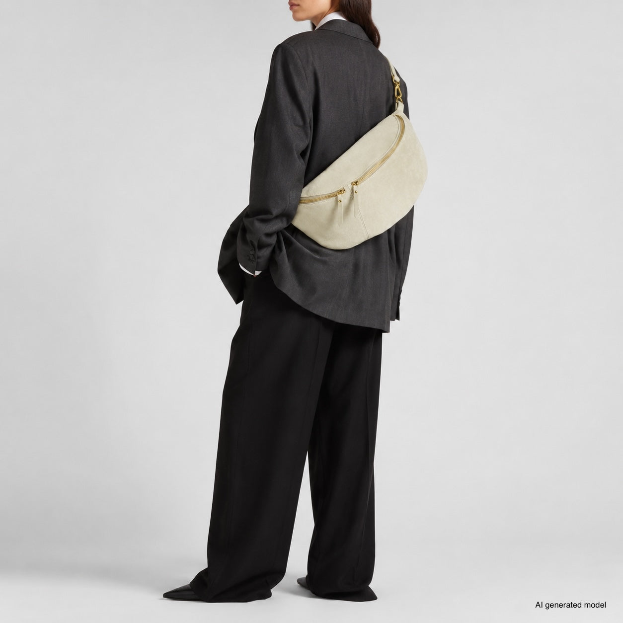 A person in an oversized dark suit stands sideways, showcasing a large real suede handbag with gold hardware. The background is plain and light, with text in the corner noting AI generated model.