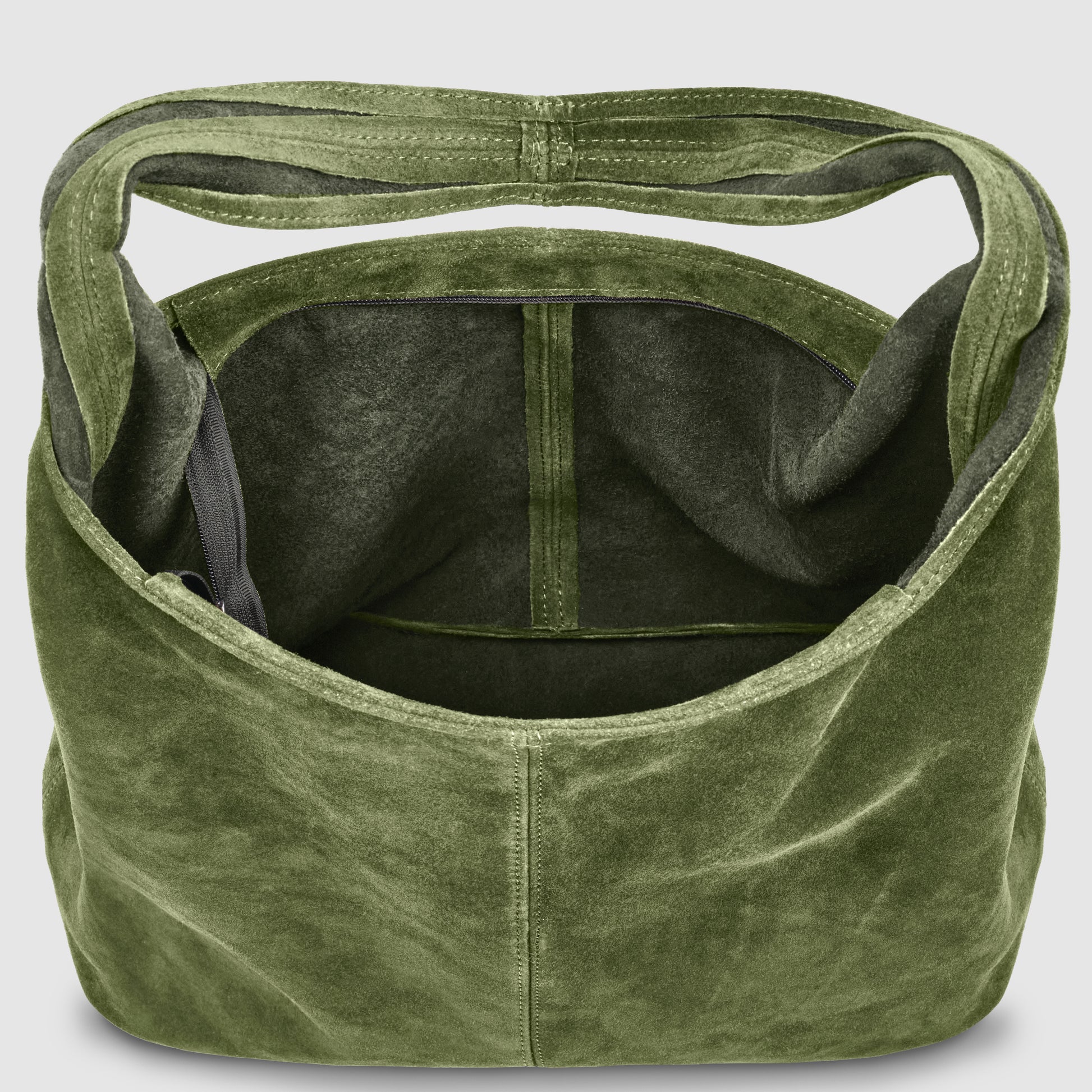 An open, olive green genuine suede leather tote bag is shown from above, revealing a spacious interior with a single pocket on one side. The soft material and unstructured shape highlight its effortless elegance.