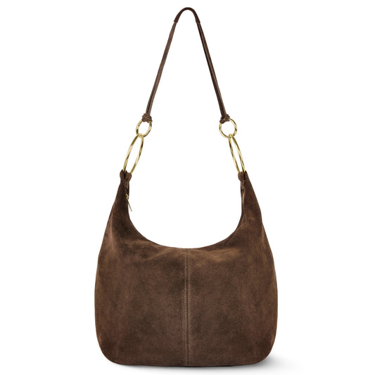 A brown suede bag with a single shoulder strap and gold-tone metal ring accents connecting the strap to the bag. This Italian handmade bag features a soft, slouchy structure and minimal design details.