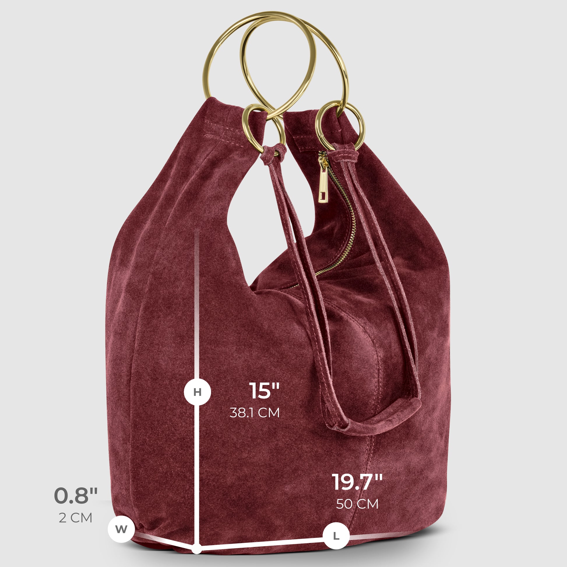 A burgundy natural suede handbag with gold circular handles, a zipper pocket, and a slouchy shape. An Italian handmade bag with dimensions: height 15 (38.1 cm), length 19.7 (50 cm), width 0.8 (2 cm).