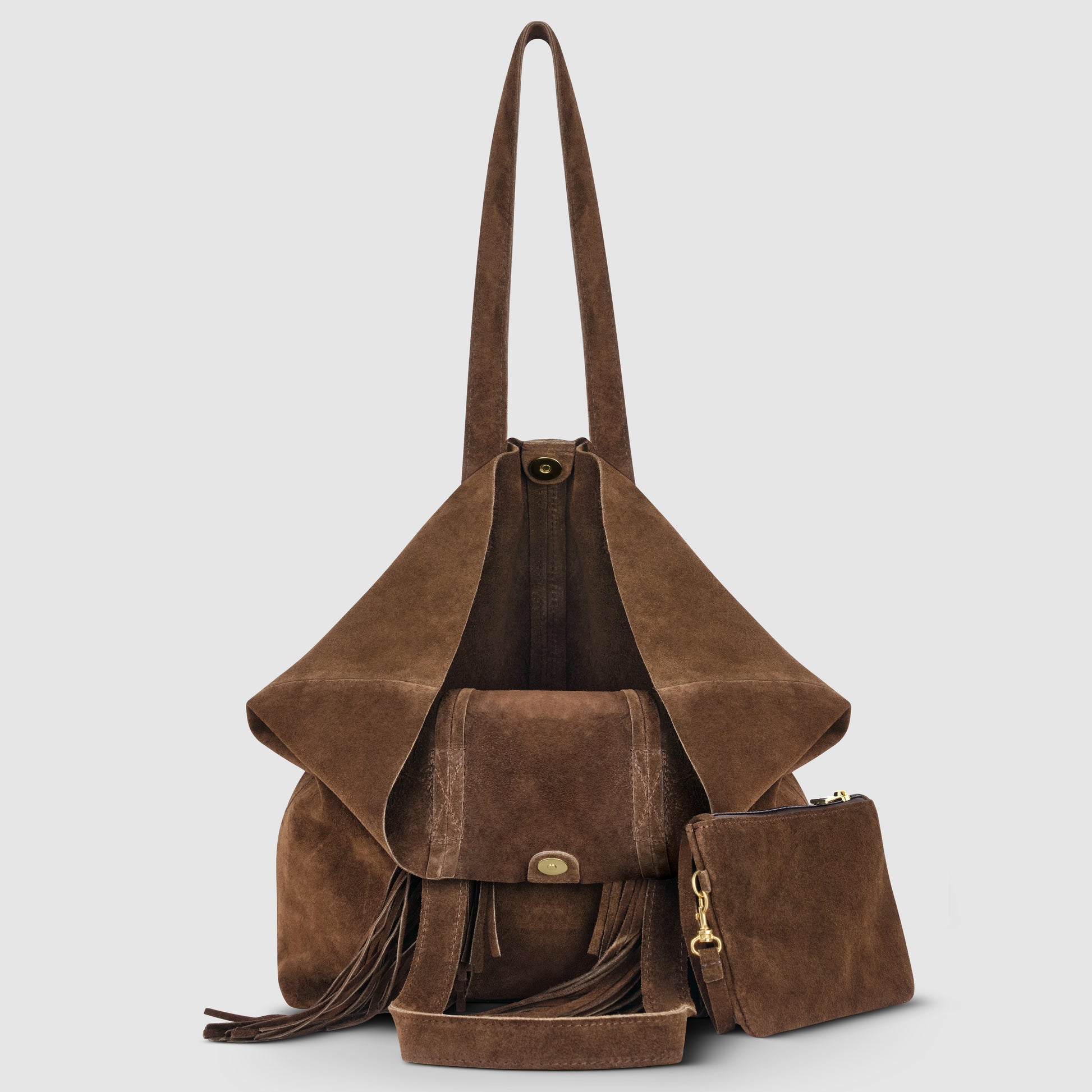 A brown suede bohemian handbag with a front flap, long shoulder straps, fringe details, and a matching detachable zippered pouch, displayed open on a light gray background.