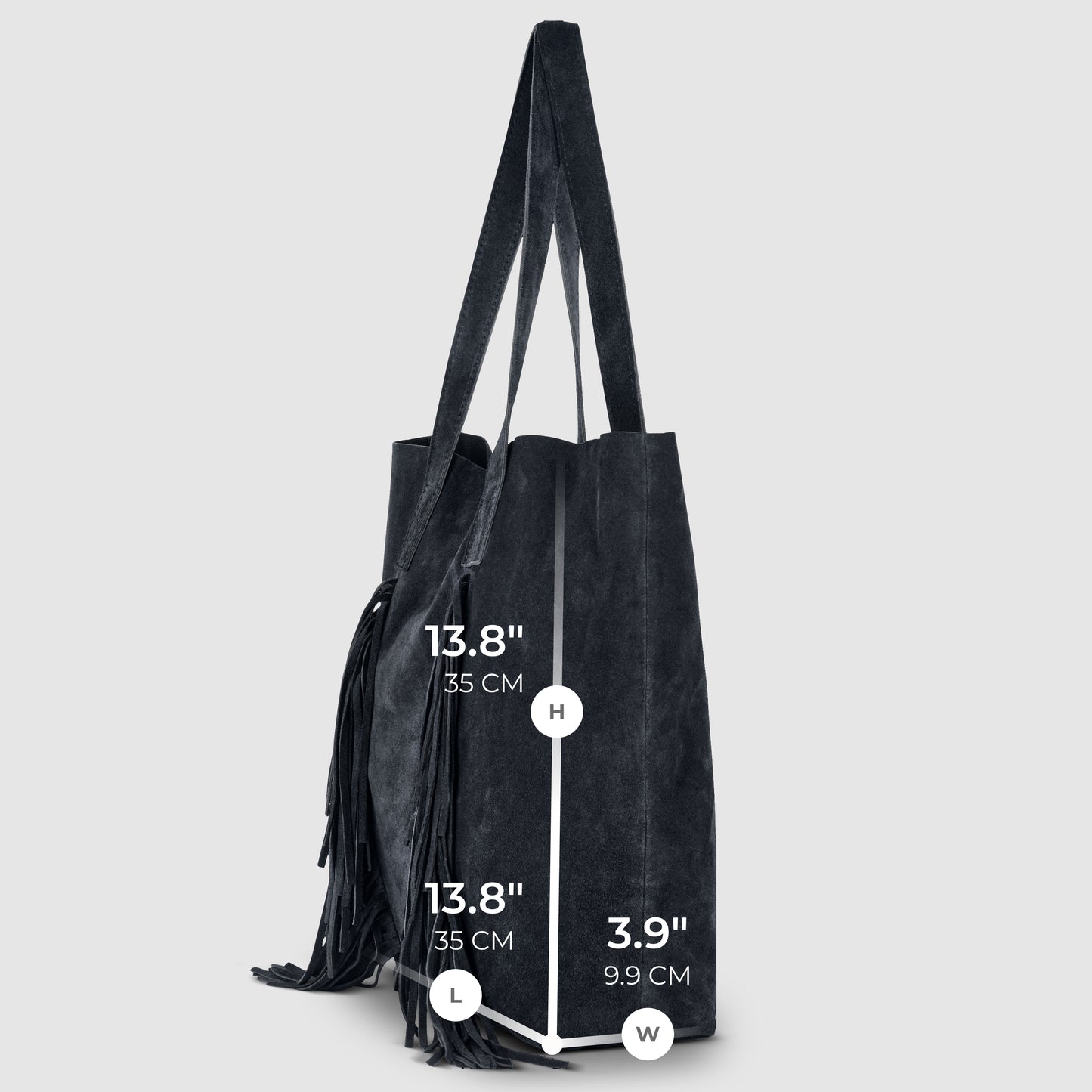A black suede handbag with two straps stands upright. Measurements: height 13.8" (35 cm), length 13.8" (35 cm), width 3.9" (9.9 cm). A fringe detail lends this bohemian handbag a stylish touch on one side.