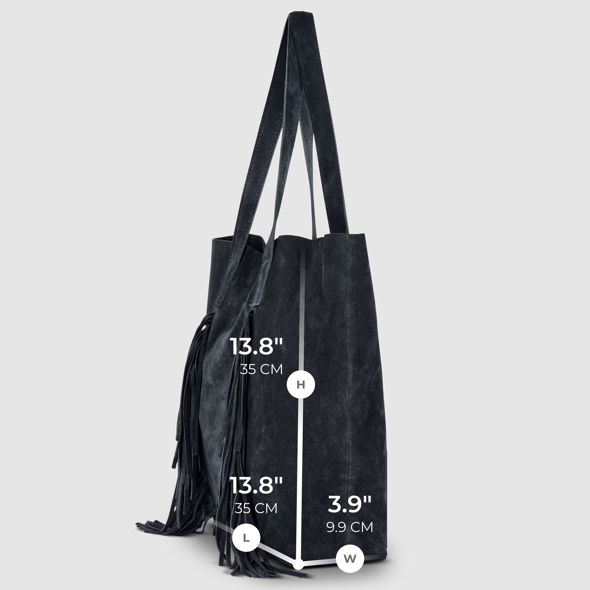 A black suede handbag with two straps stands upright. Measurements: height 13.8" (35 cm), length 13.8" (35 cm), width 3.9" (9.9 cm). A fringe detail lends this bohemian handbag a stylish touch on one side.
