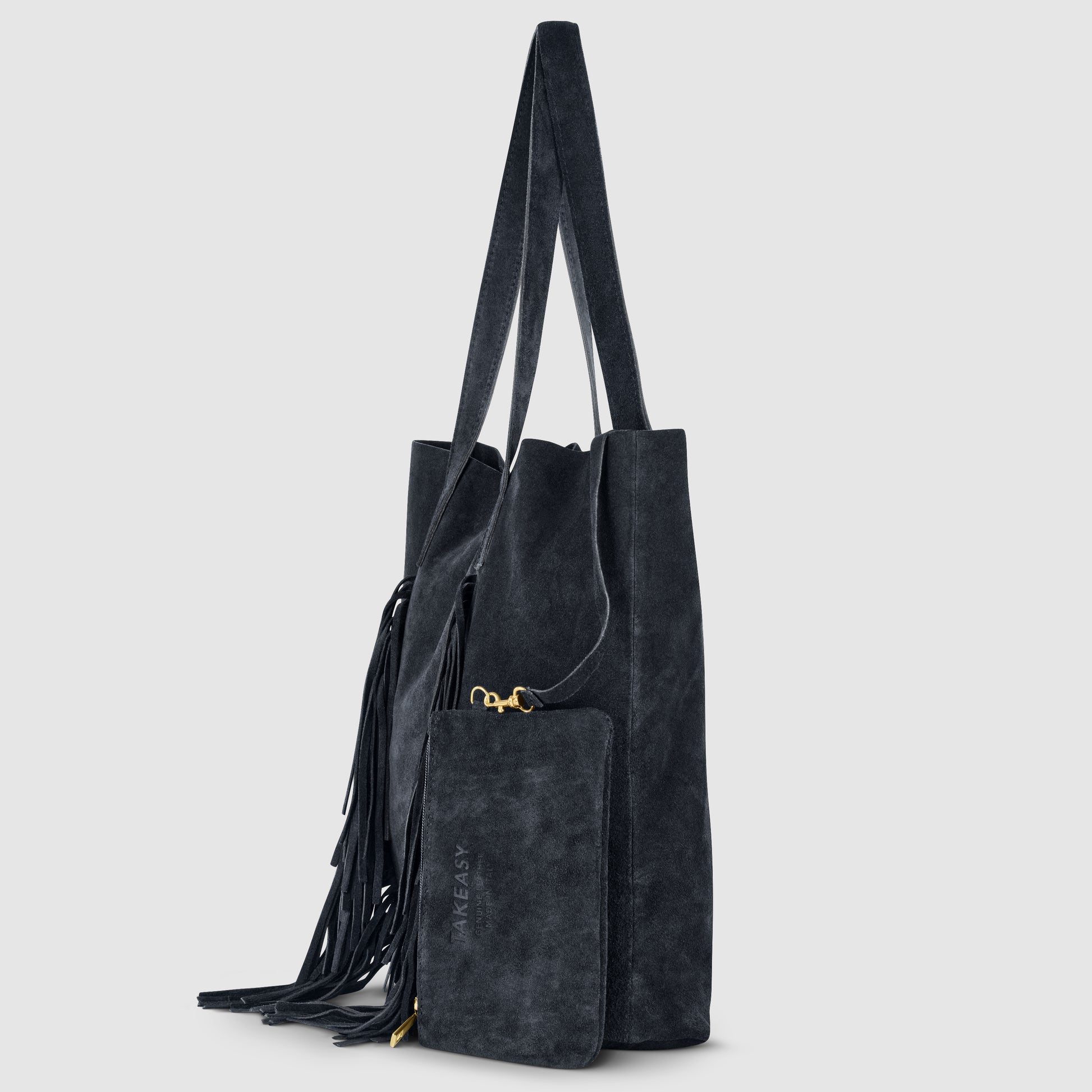 A black suede handbag with long handles, fringed side detailing, and a matching zippered pouch attached by a gold clasp, displayed against a plain light gray background.