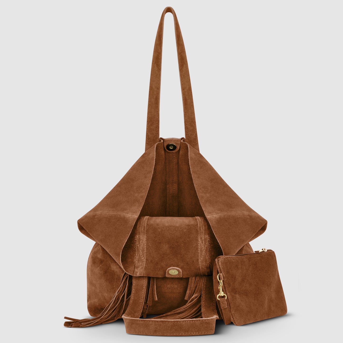 A brown bohemian handbag in suede with a flap closure, long shoulder straps, tassel details, and an attached matching zippered pouch, photographed against a plain light gray background.