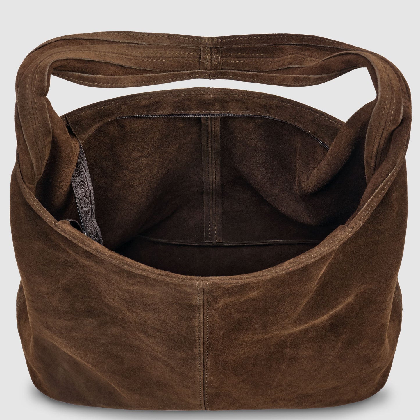 Open brown slouchy suede shoulder purse with a wide handle, showing the spacious interior and a small inner pocket against a plain light background.