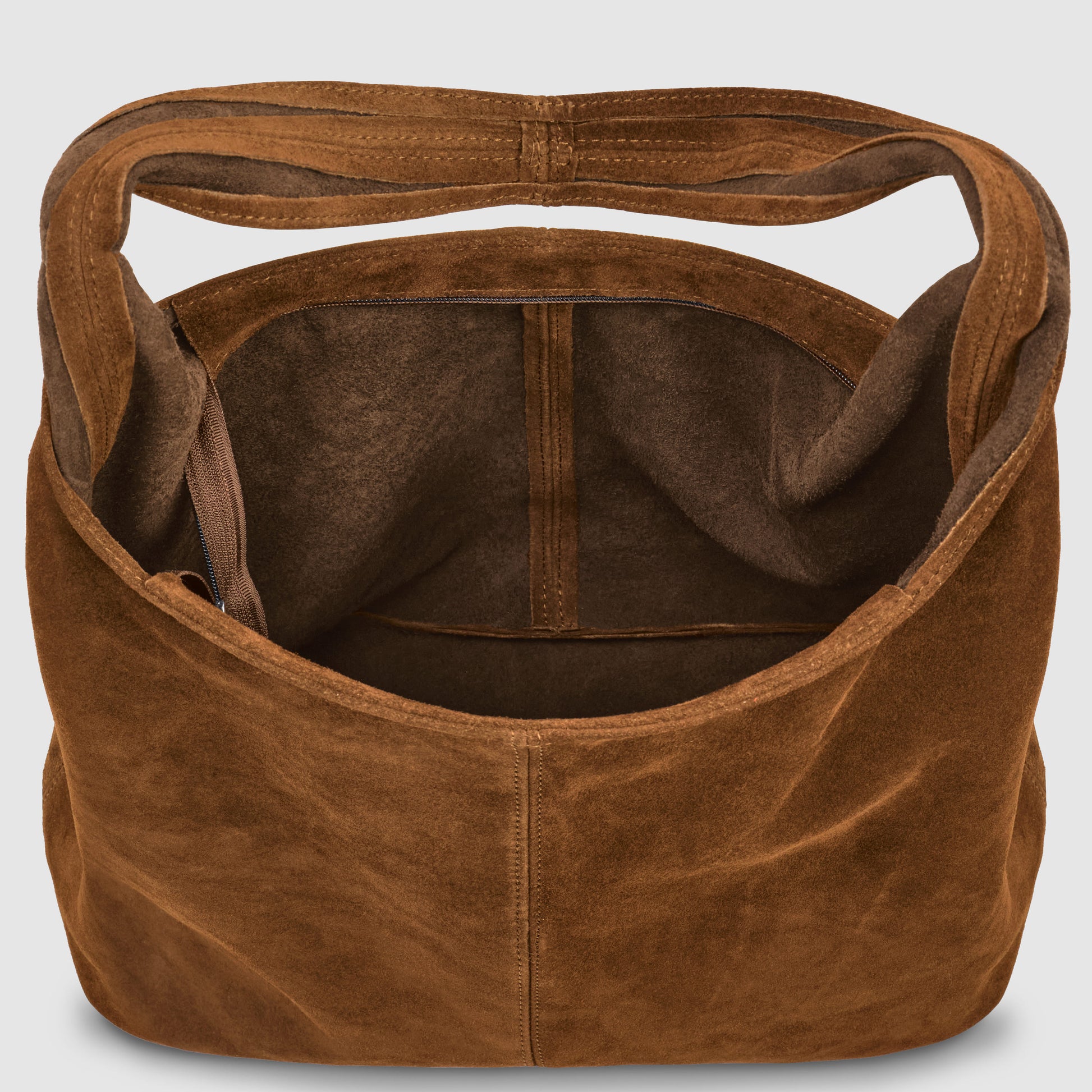 A spacious natural suede handbag with a wide strap and open top, showcasing its roomy, unlined interior and convenient side pocket inside.