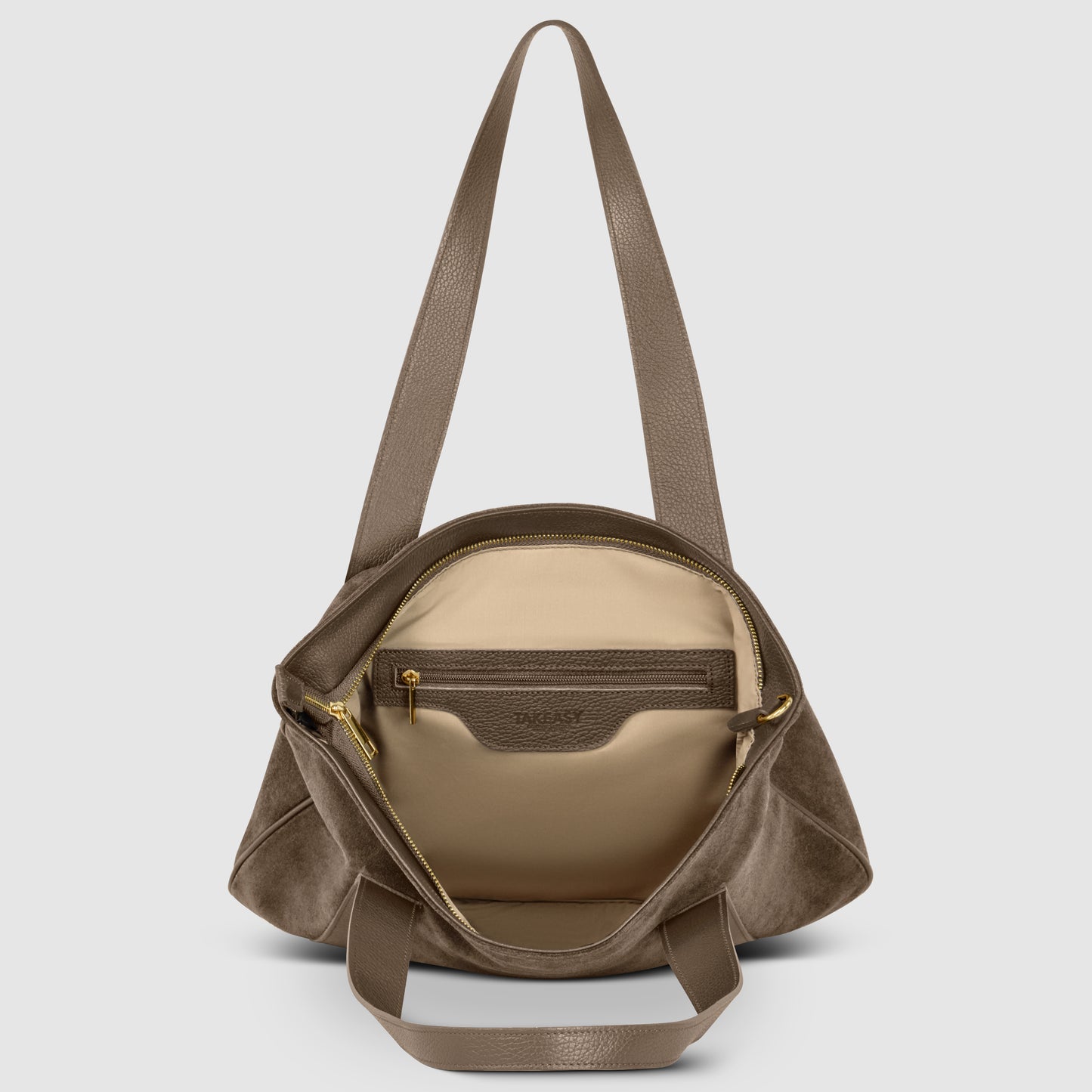 A genuine suede handbag with long handles, shown open to reveal a beige interior lining, a zippered inner pocket, and gold zipper detailing.