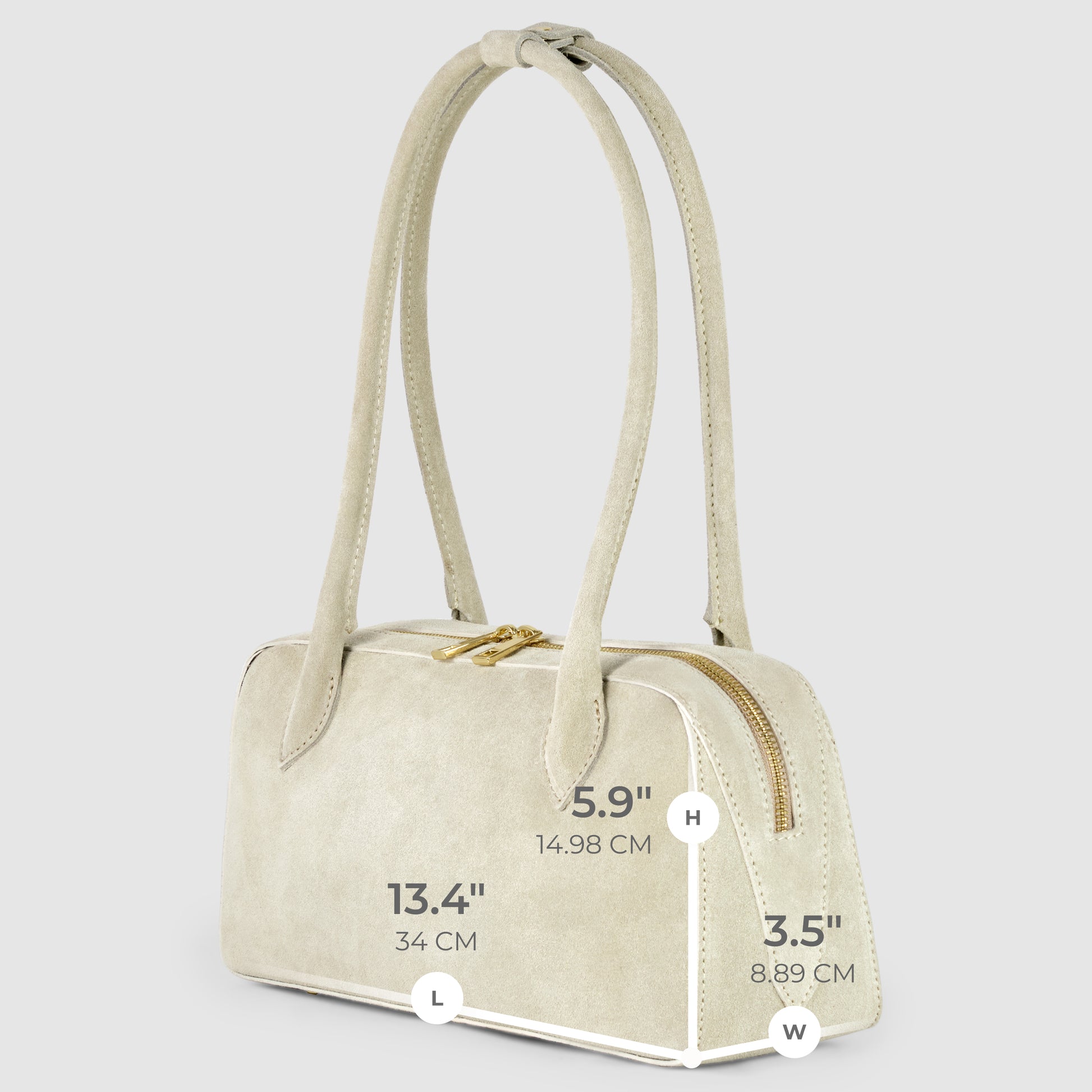 A light beige Italian suede leather bag with two long handles, a gold zipper, and visible dimensions: height 5.9" (14.98 cm), length 13.4" (34 cm), and width 3.5" (8.89 cm), displayed on a light gray background.