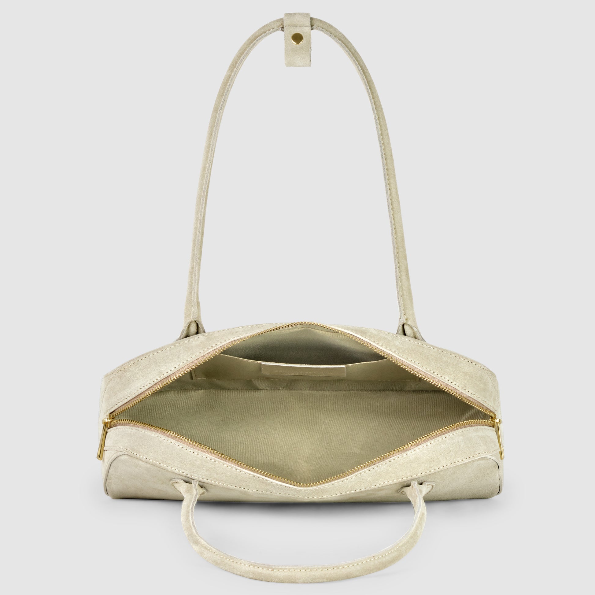 A beige Italian suede leather bag with two handles is shown open, revealing an empty interior and a gold zipper. The bag is displayed against a plain light gray background.