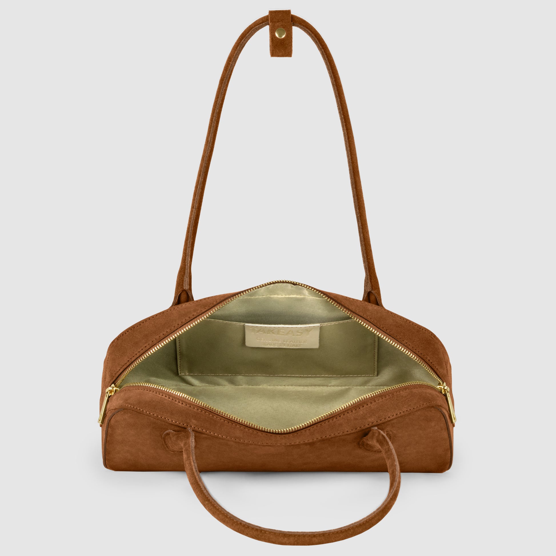 A genuine suede bag with gold zippers, shown open to reveal a light green fabric interior and an inner pocket. The bag features two handles and a detachable shoulder strap for versatile style.