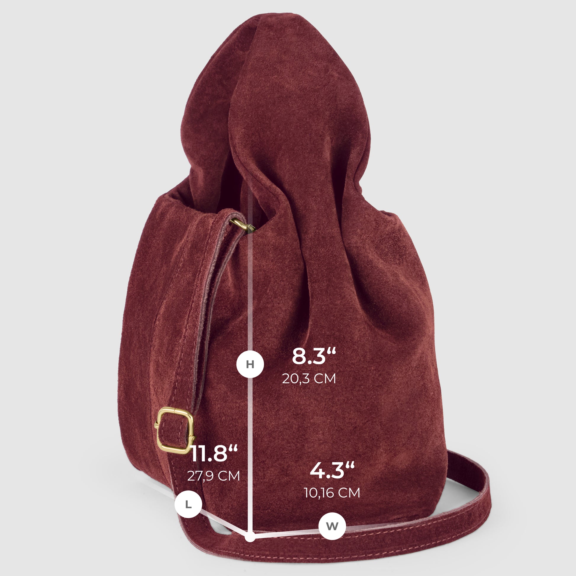 A handcrafted Italian suede bag is shown standing upright with its strap extended. Measurements are labeled: height 8.3" (20.3 cm), length 11.8" (27.9 cm), and width 4.3" (10.16 cm).